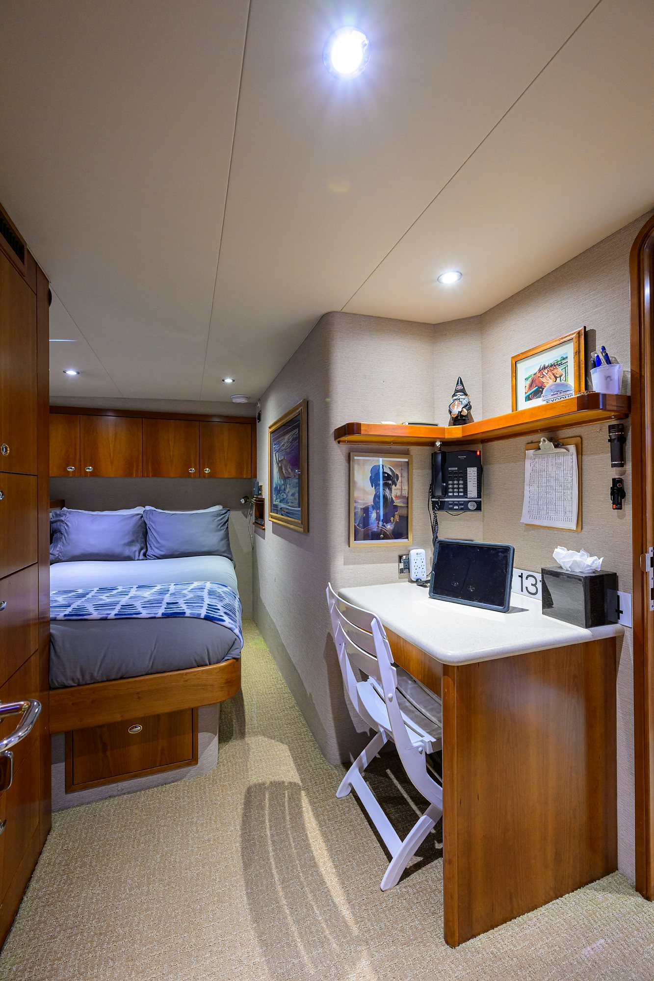 a bedroom with a desk and a bed aboard EXODUS Yacht for Sale