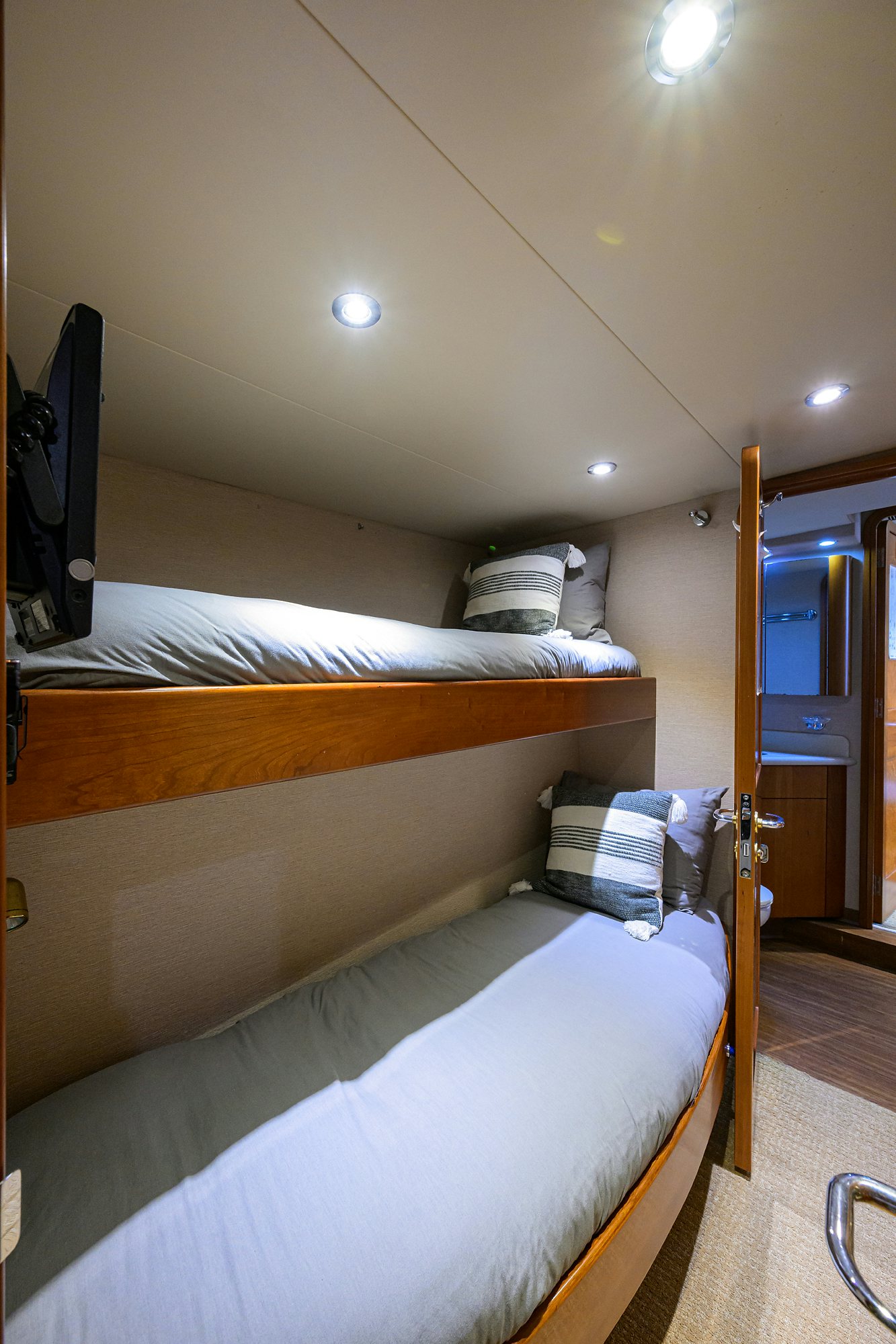 a room with a bed and a television aboard EXODUS Yacht for Sale