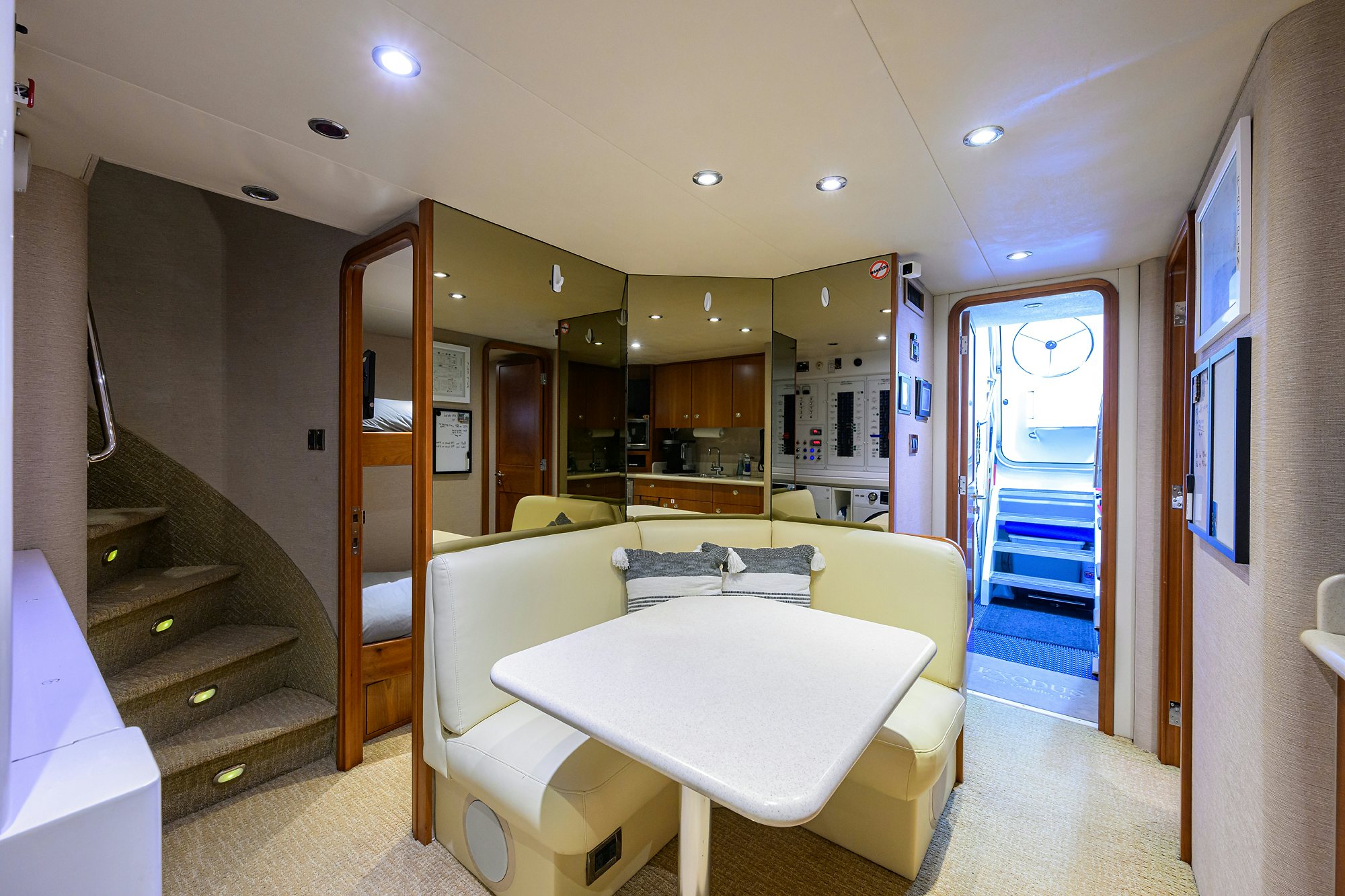 a room with a table and chairs aboard EXODUS Yacht for Sale