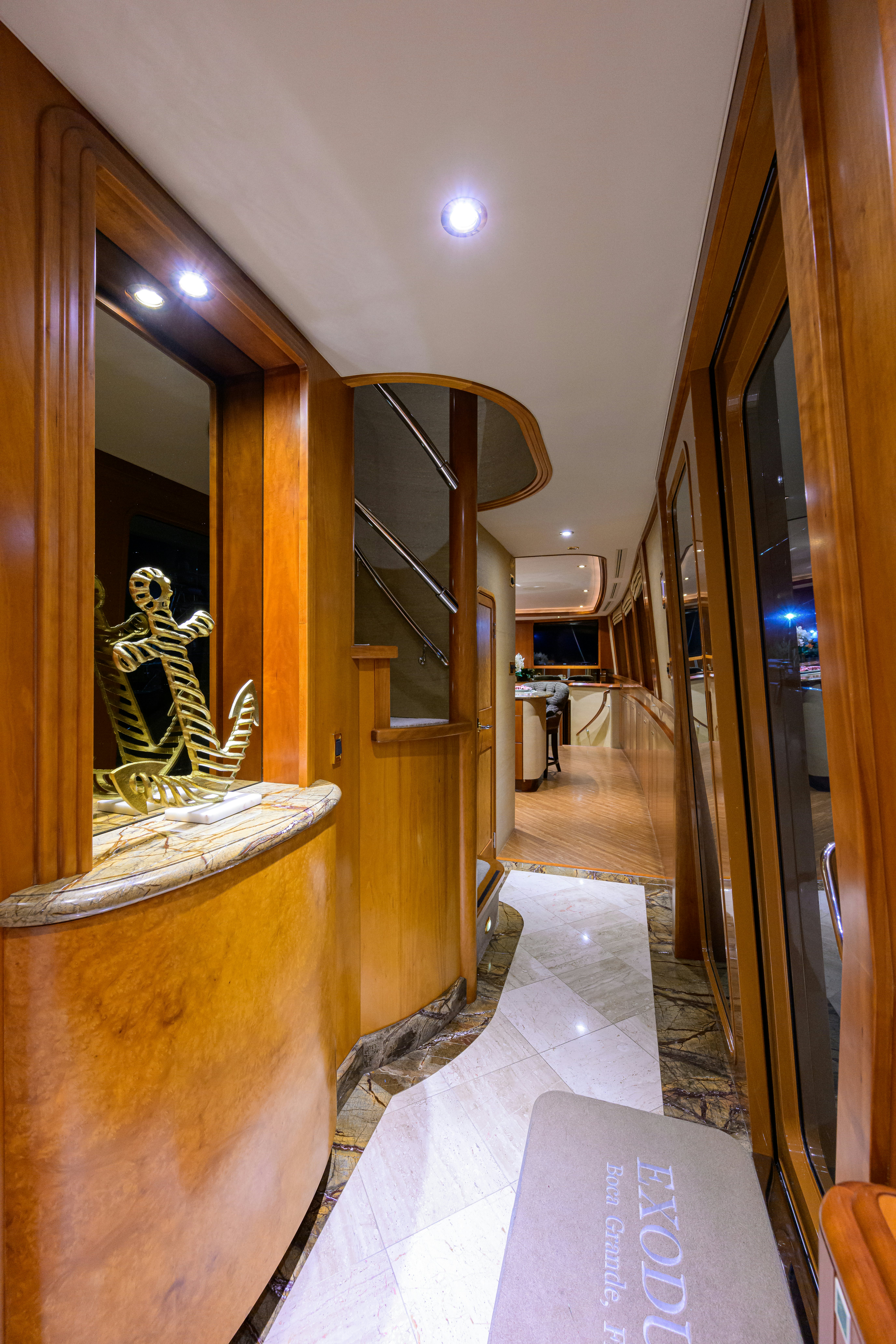 a hallway with a mirror and a statue in the middle aboard EXODUS Yacht for Sale