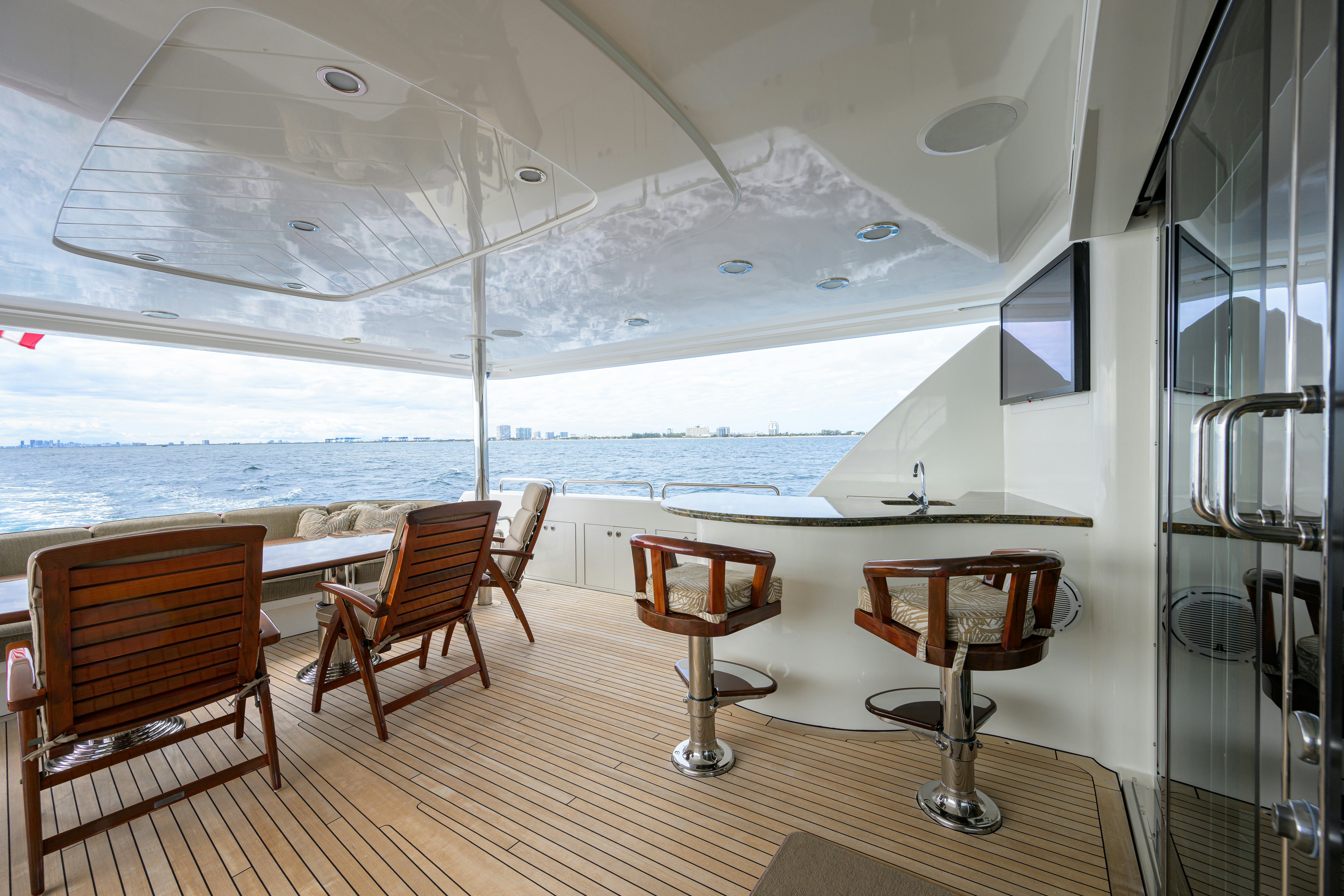 a room with a table chairs and a large body of water aboard EXODUS Yacht for Sale