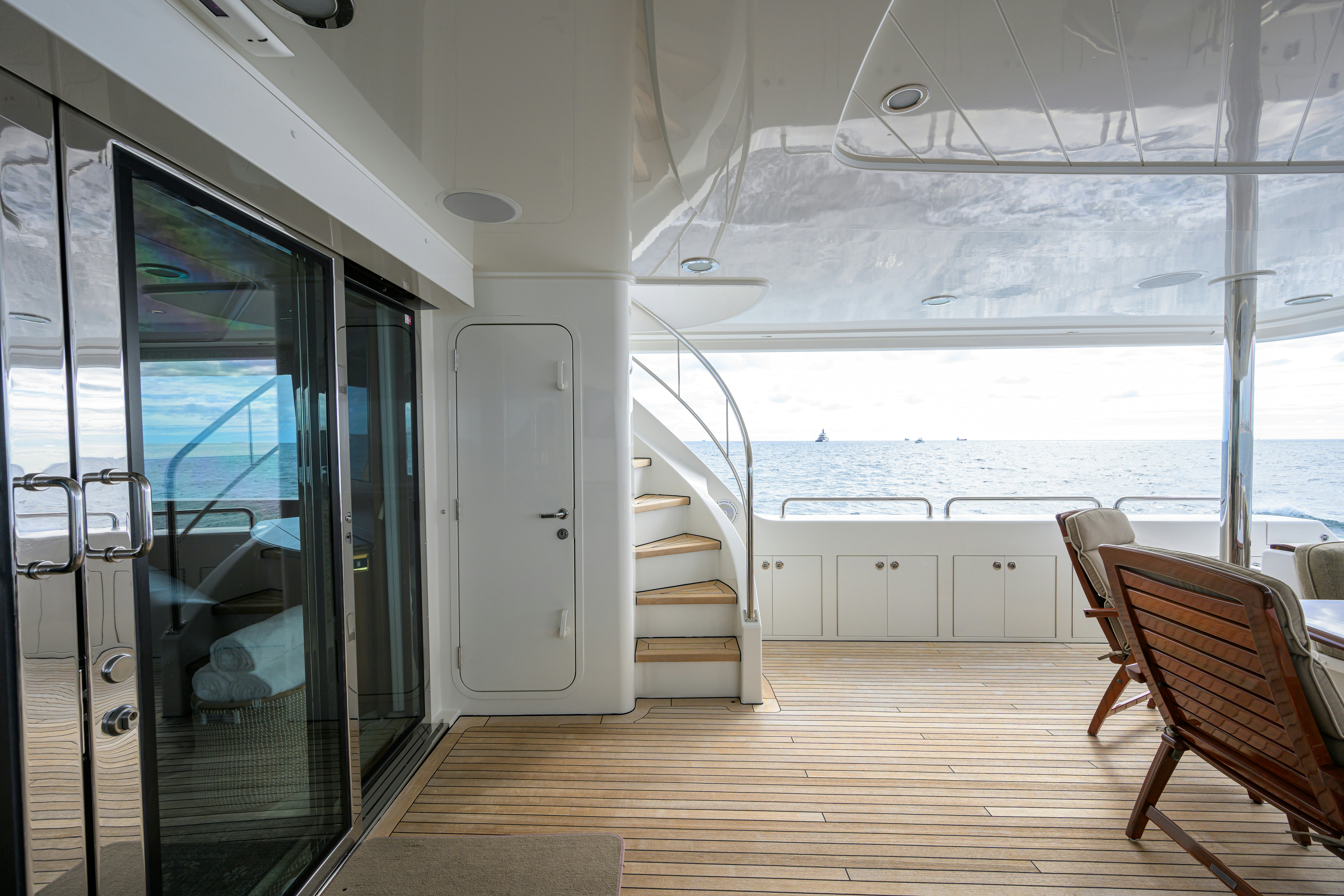 a room with a view of the ocean and a staircase aboard EXODUS Yacht for Sale