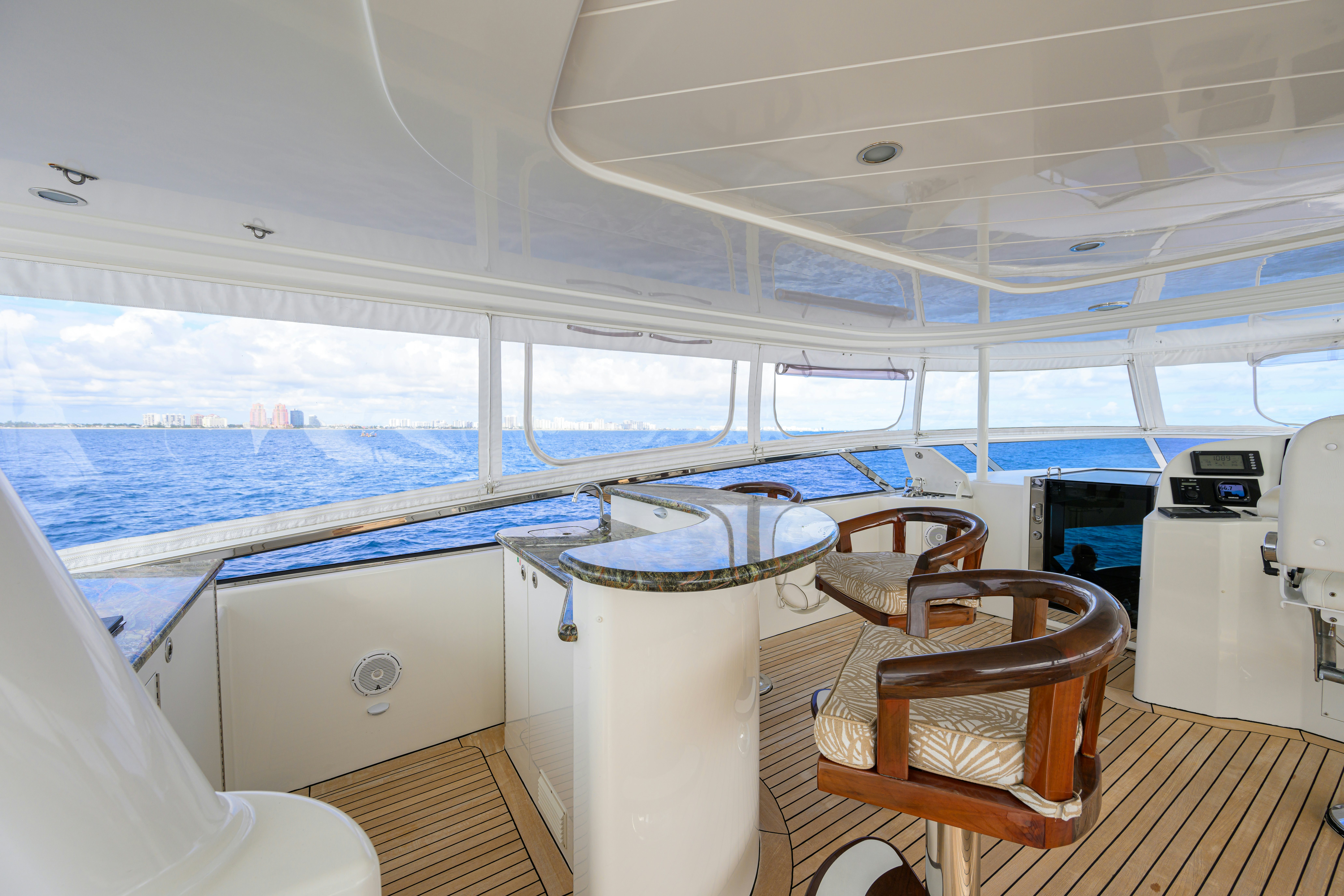 a boat with a table and chairs aboard EXODUS Yacht for Sale