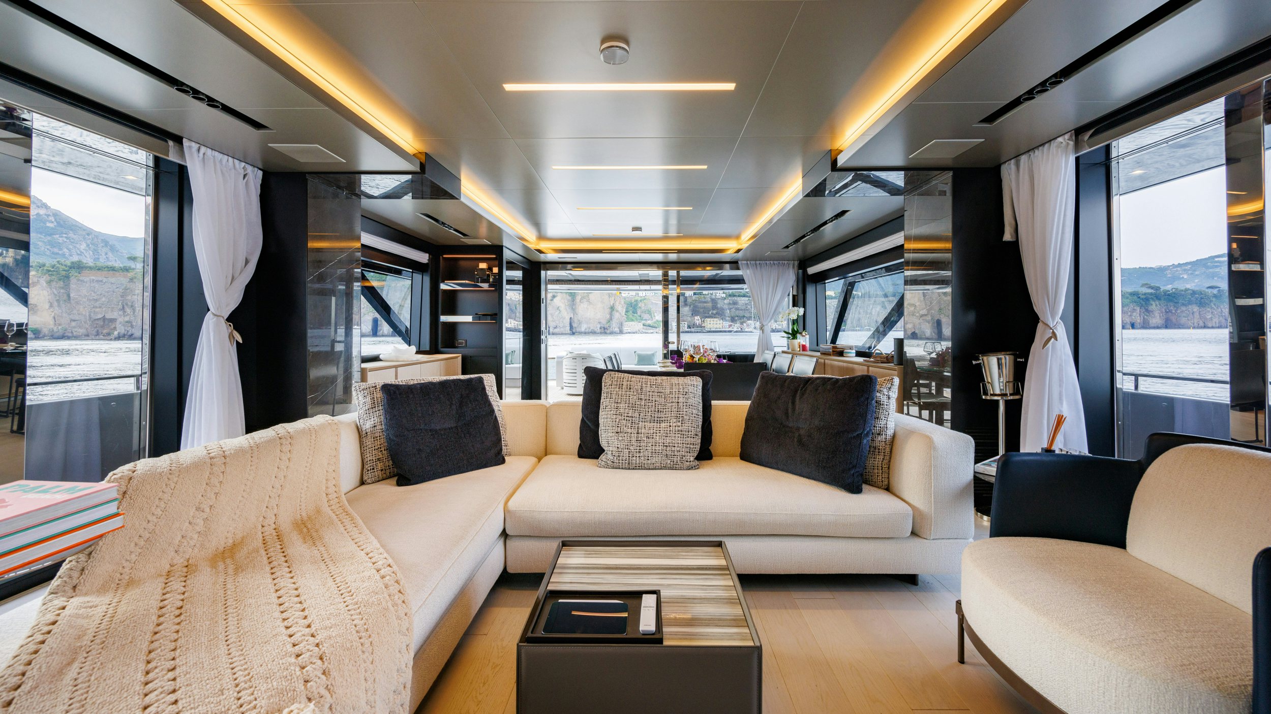 a living room with a couch and a table aboard STILE DI VITA Yacht for Sale
