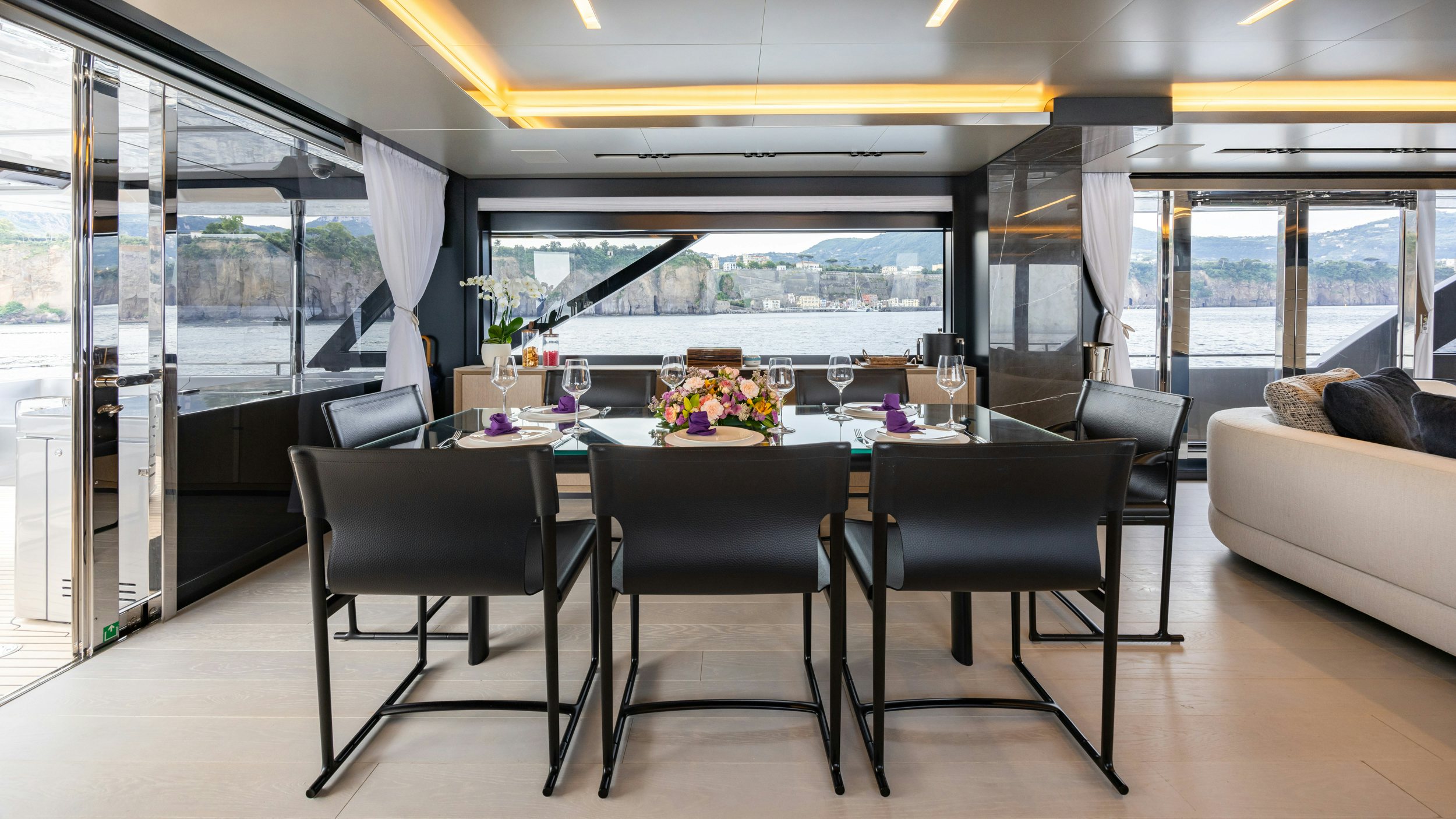 a large dining table in a room aboard STILE DI VITA Yacht for Sale