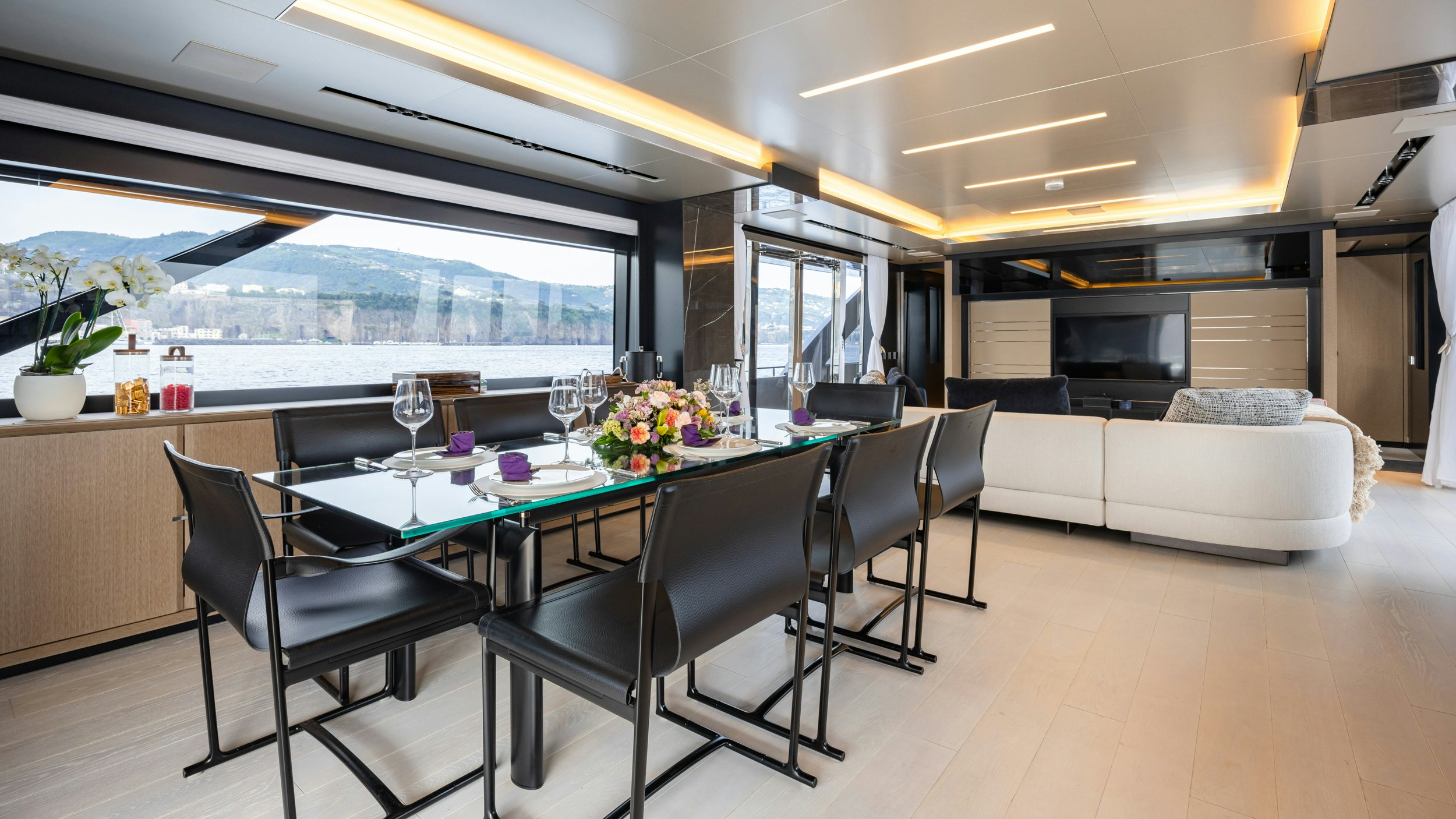 a room with a table and chairs aboard STILE DI VITA Yacht for Sale
