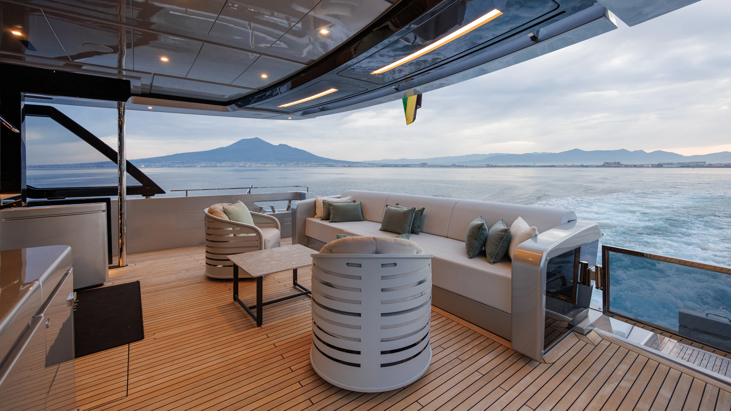 a room with a couch and a table and a large body of water aboard STILE DI VITA Yacht for Charter