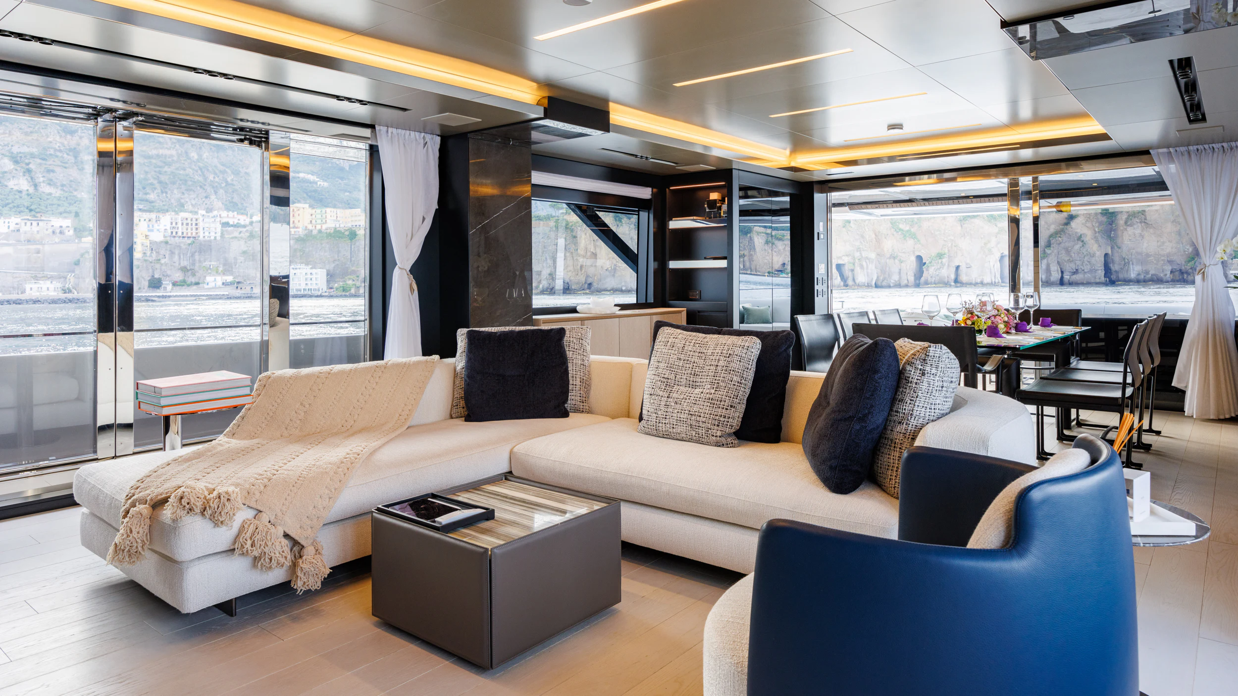 a living room with a large window aboard STILE DI VITA Yacht for Charter