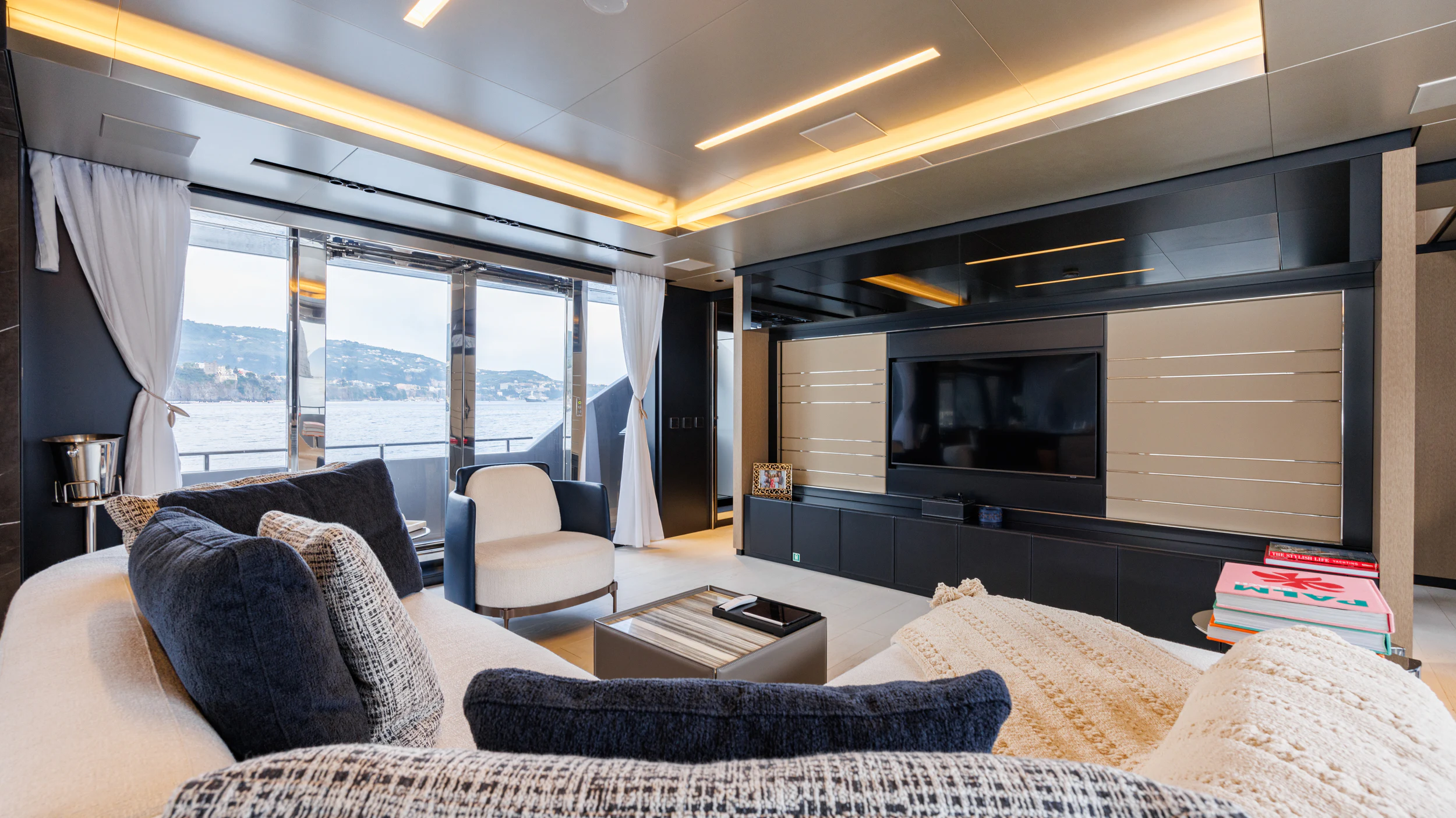 a living room with a large window aboard STILE DI VITA Yacht for Charter