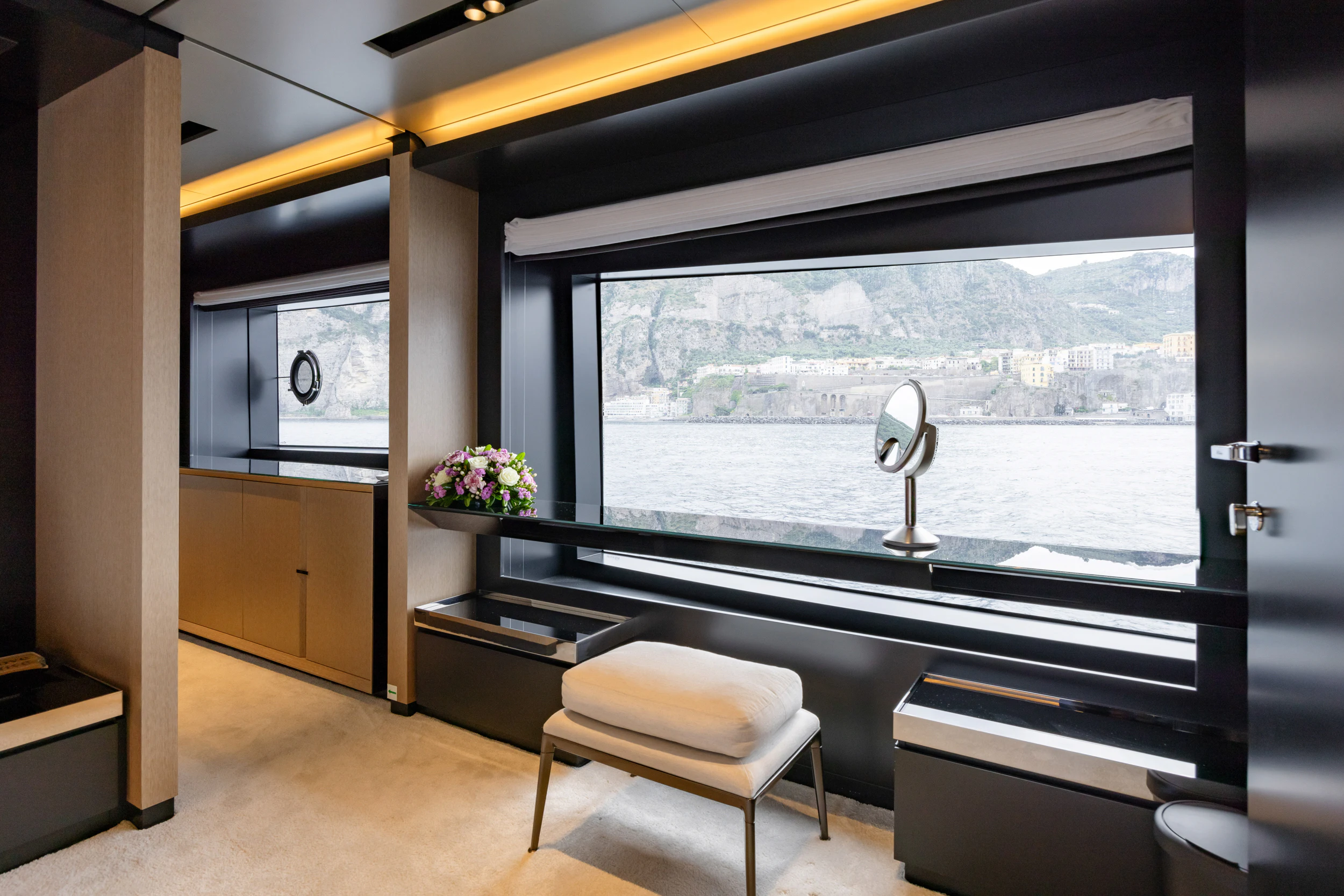 a room with a large window and a view of a city aboard STILE DI VITA Yacht for Charter