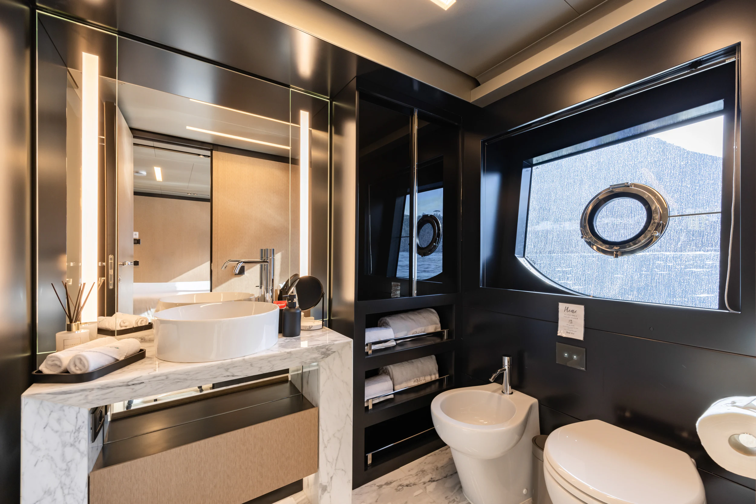 a bathroom with a large mirror aboard STILE DI VITA Yacht for Charter