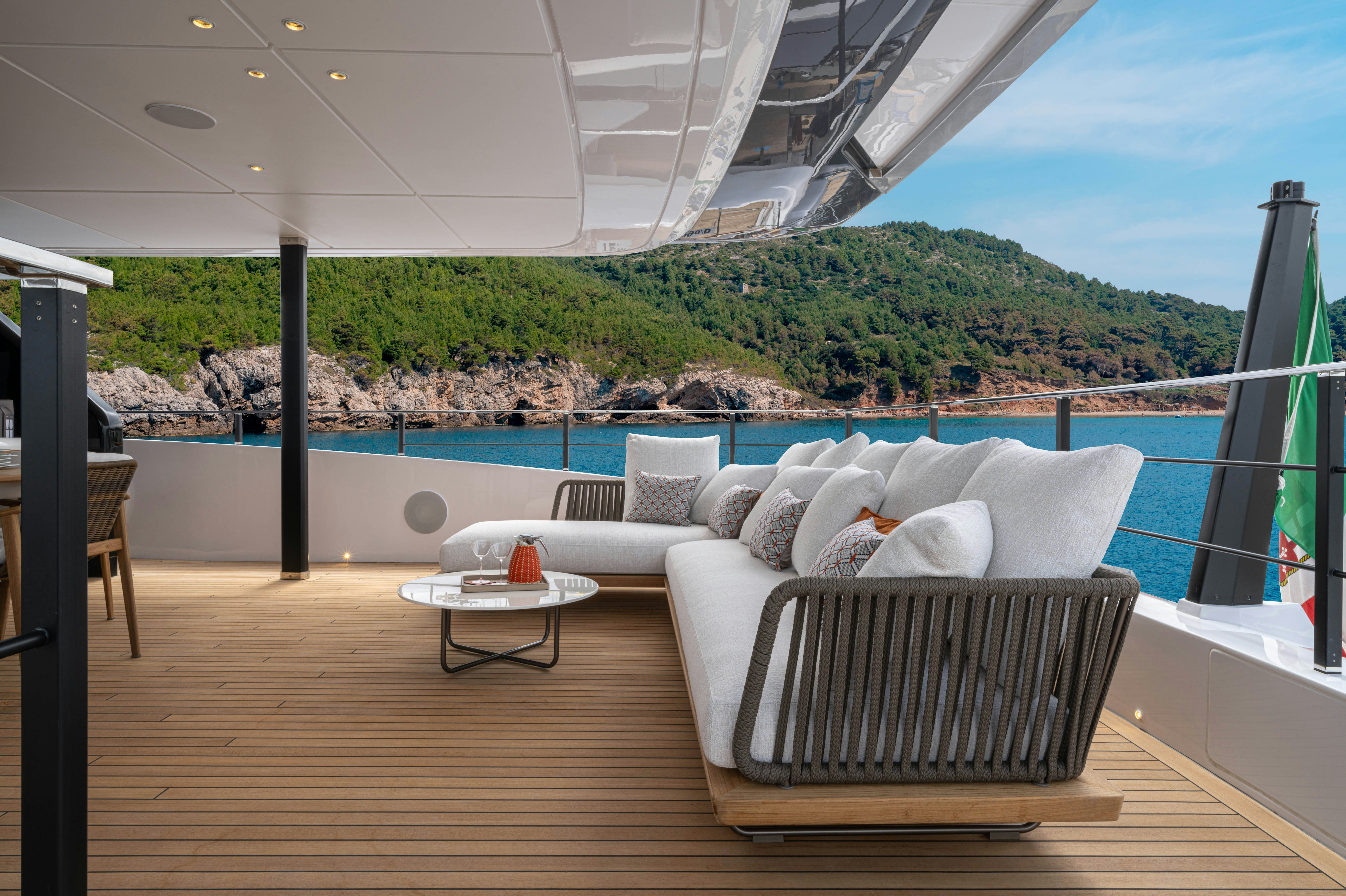 a large patio with a large body of water and a large building aboard CANOE CANOE Yacht for Charter