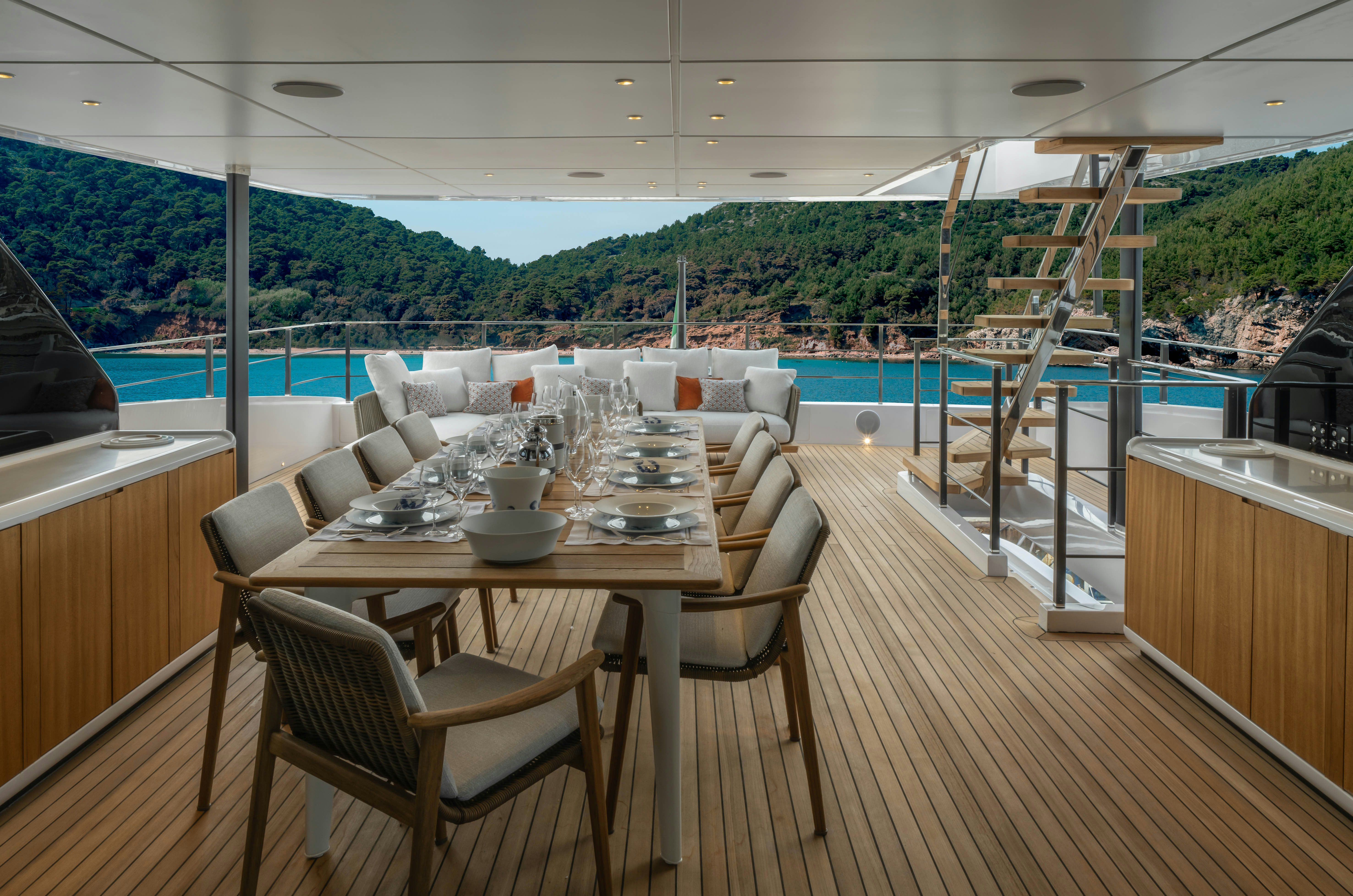 a table and chairs on a deck aboard CANOE CANOE Yacht for Charter