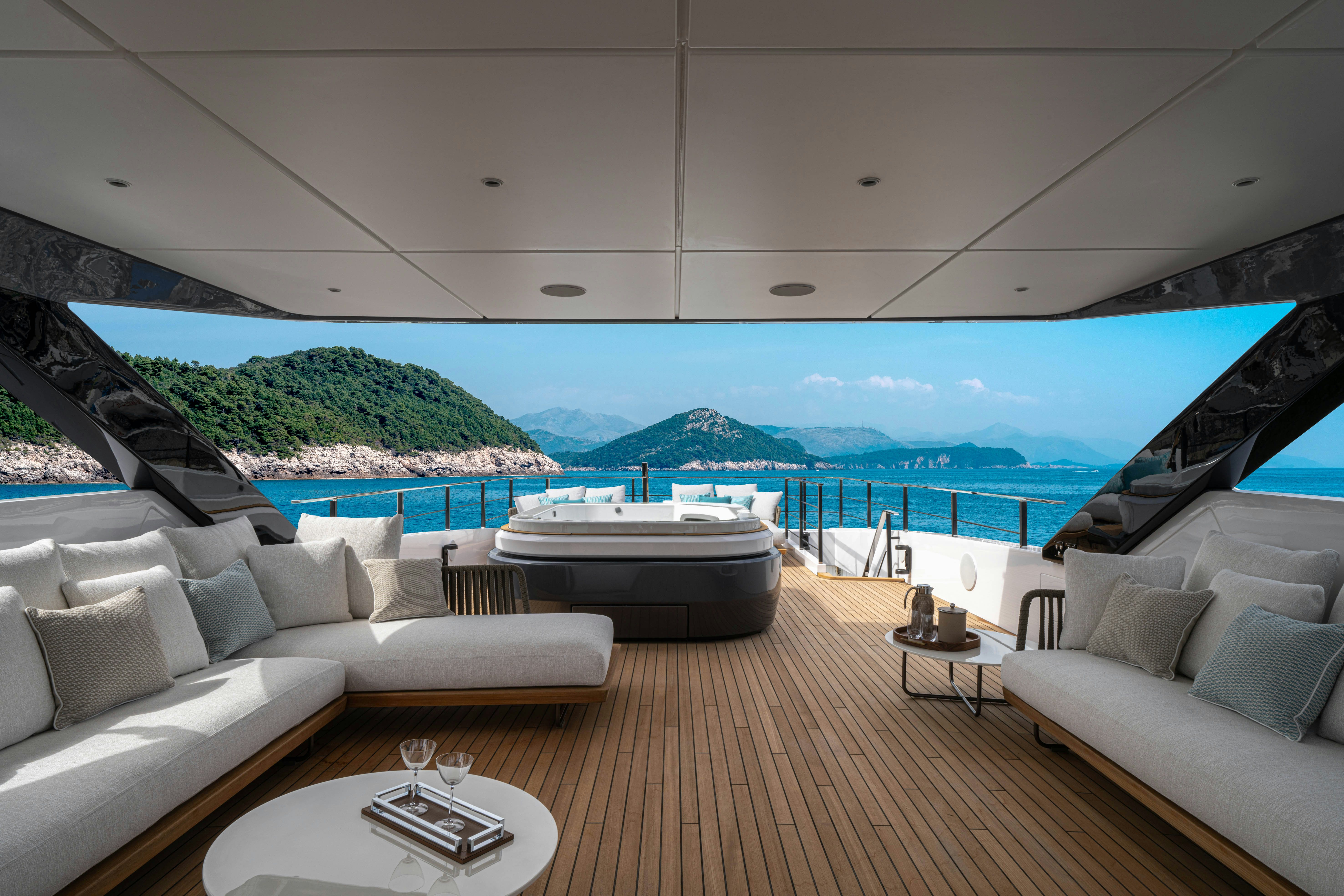 a large living room with a large body of water and a large ship in the distance aboard CANOE CANOE Yacht for Charter