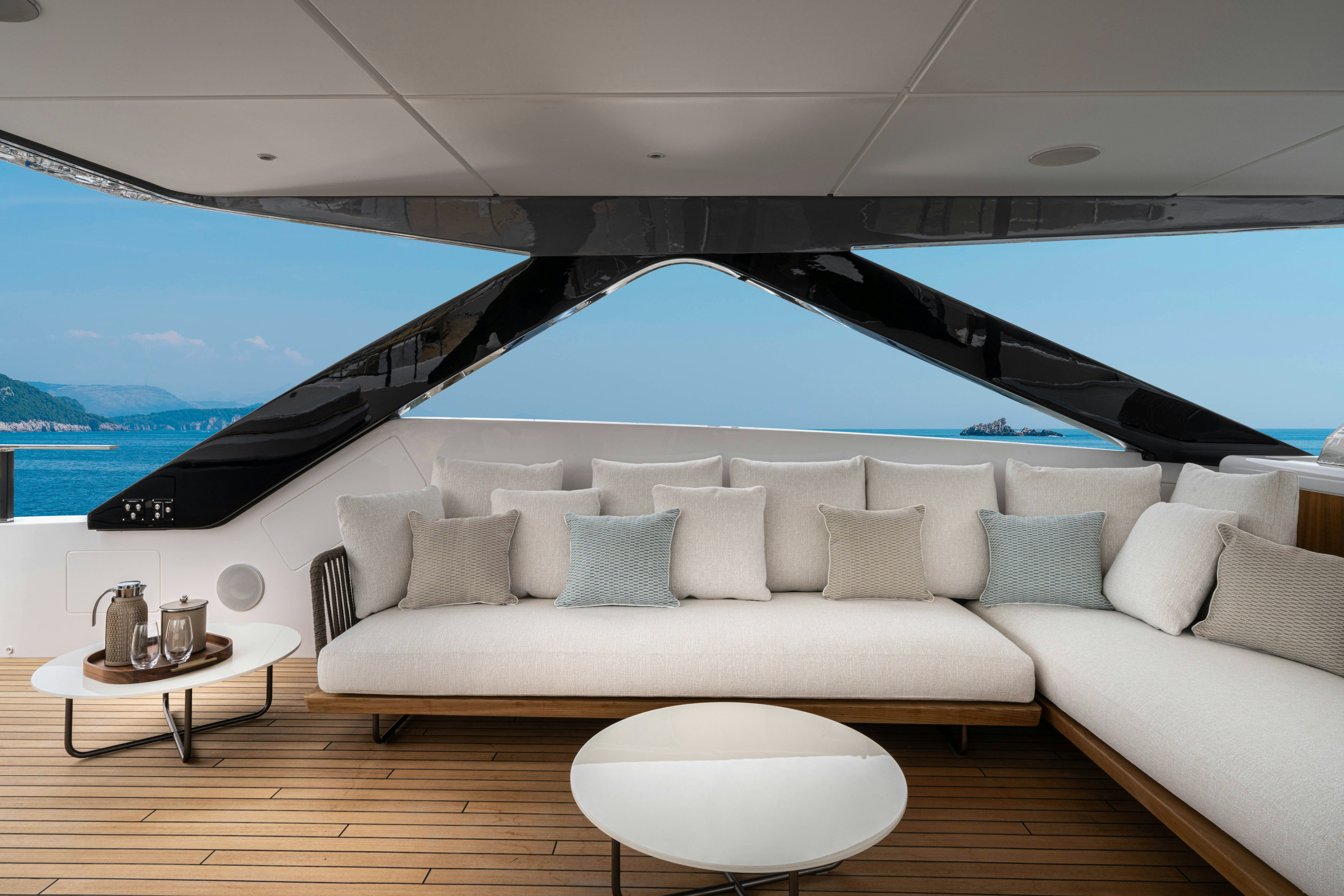 a large white sofa in a room with a large blue and white striped ceiling and a large white aboard CANOE CANOE Yacht for Charter