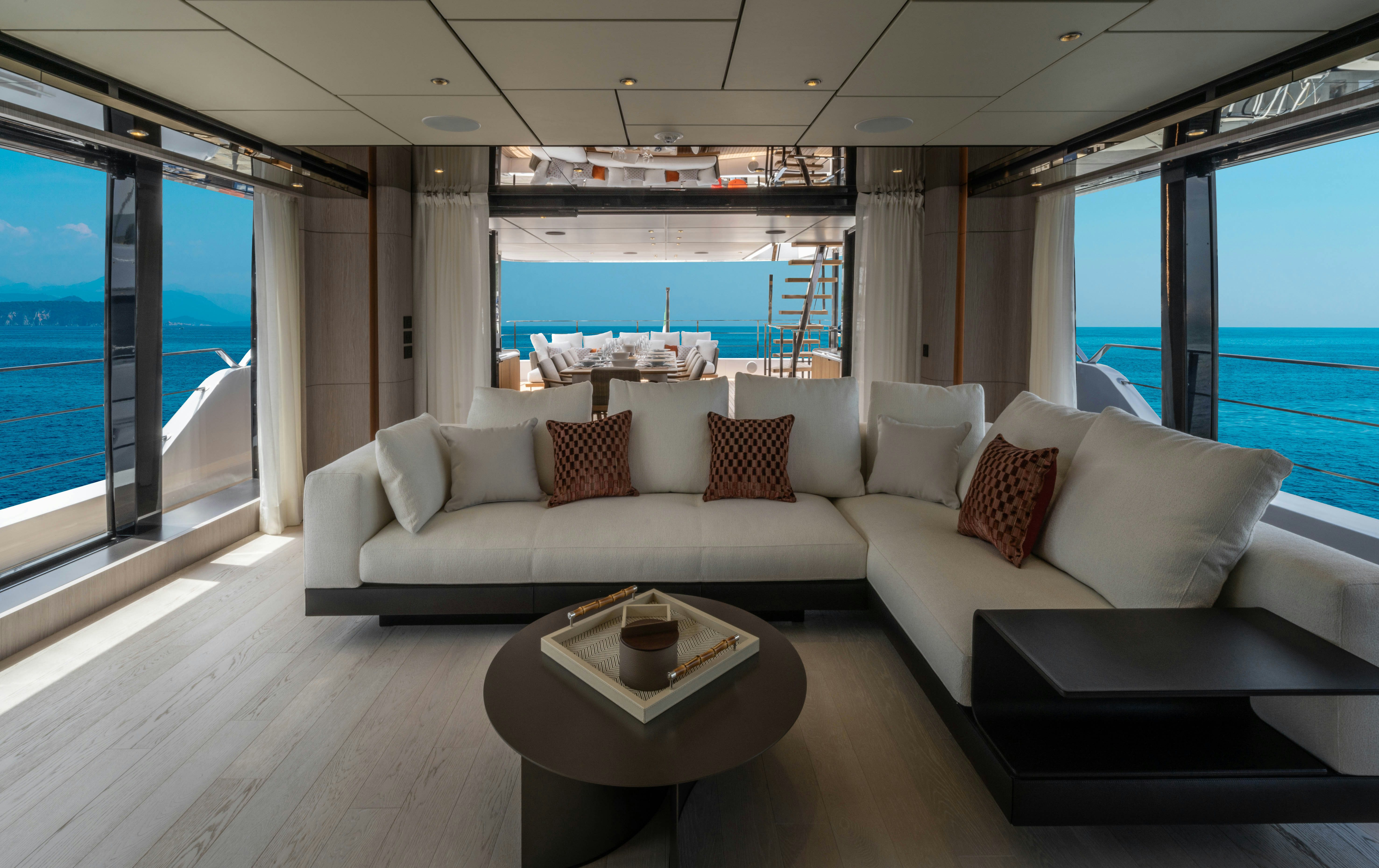 a living room with a large window aboard CANOE CANOE Yacht for Charter