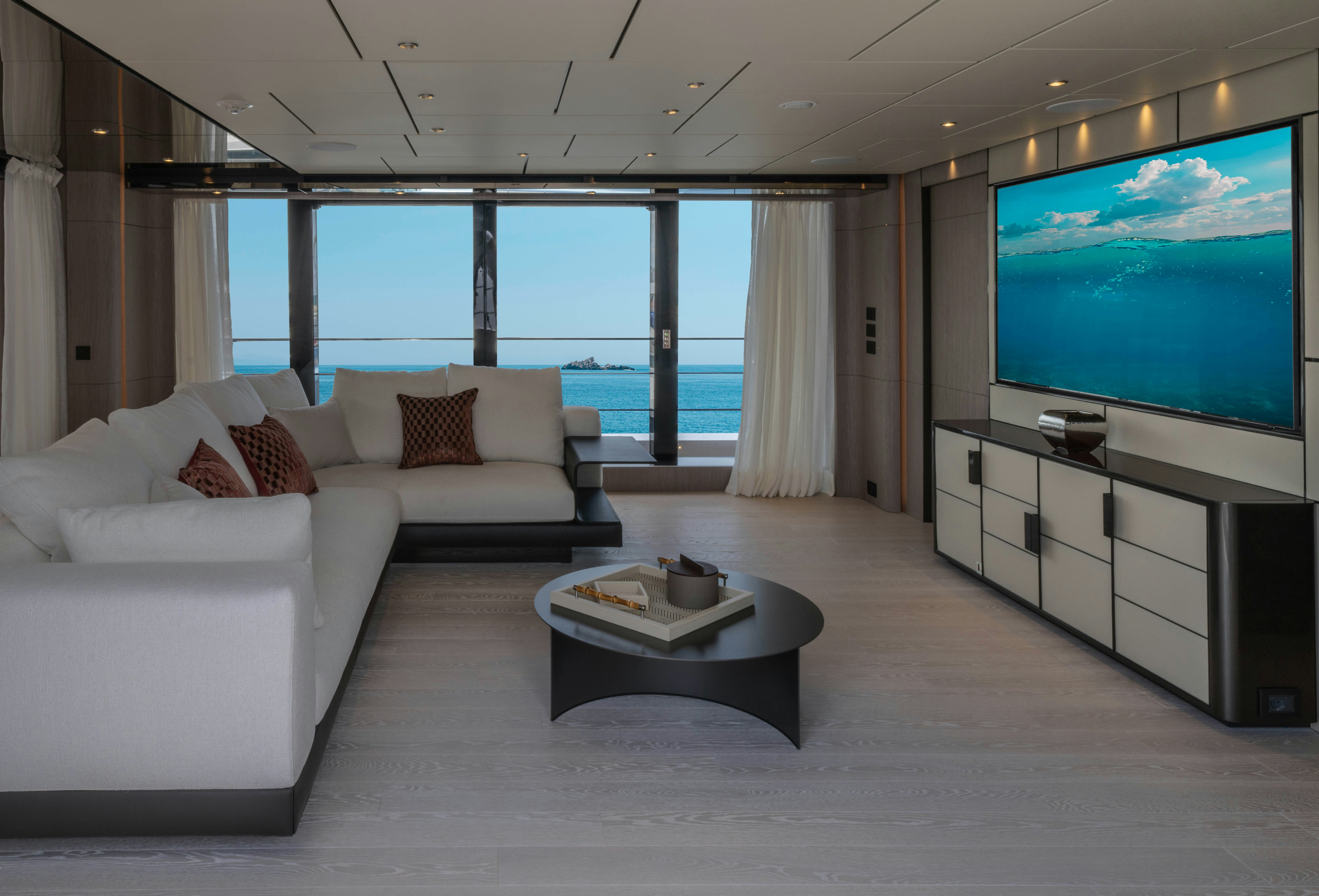 a living room with a large screen aboard CANOE CANOE Yacht for Charter