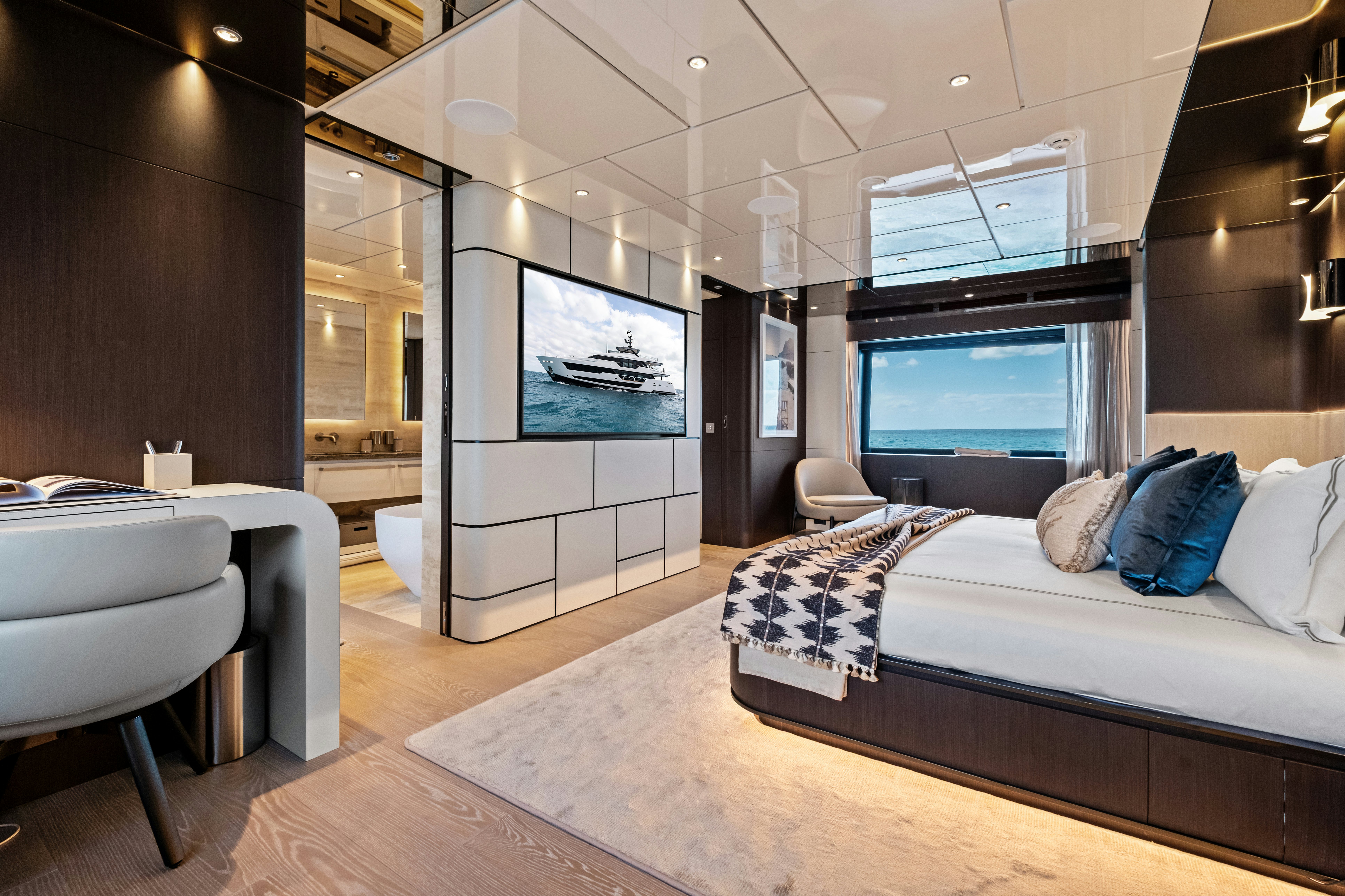 a bedroom with a bed and a tv aboard CANOE CANOE Yacht for Charter