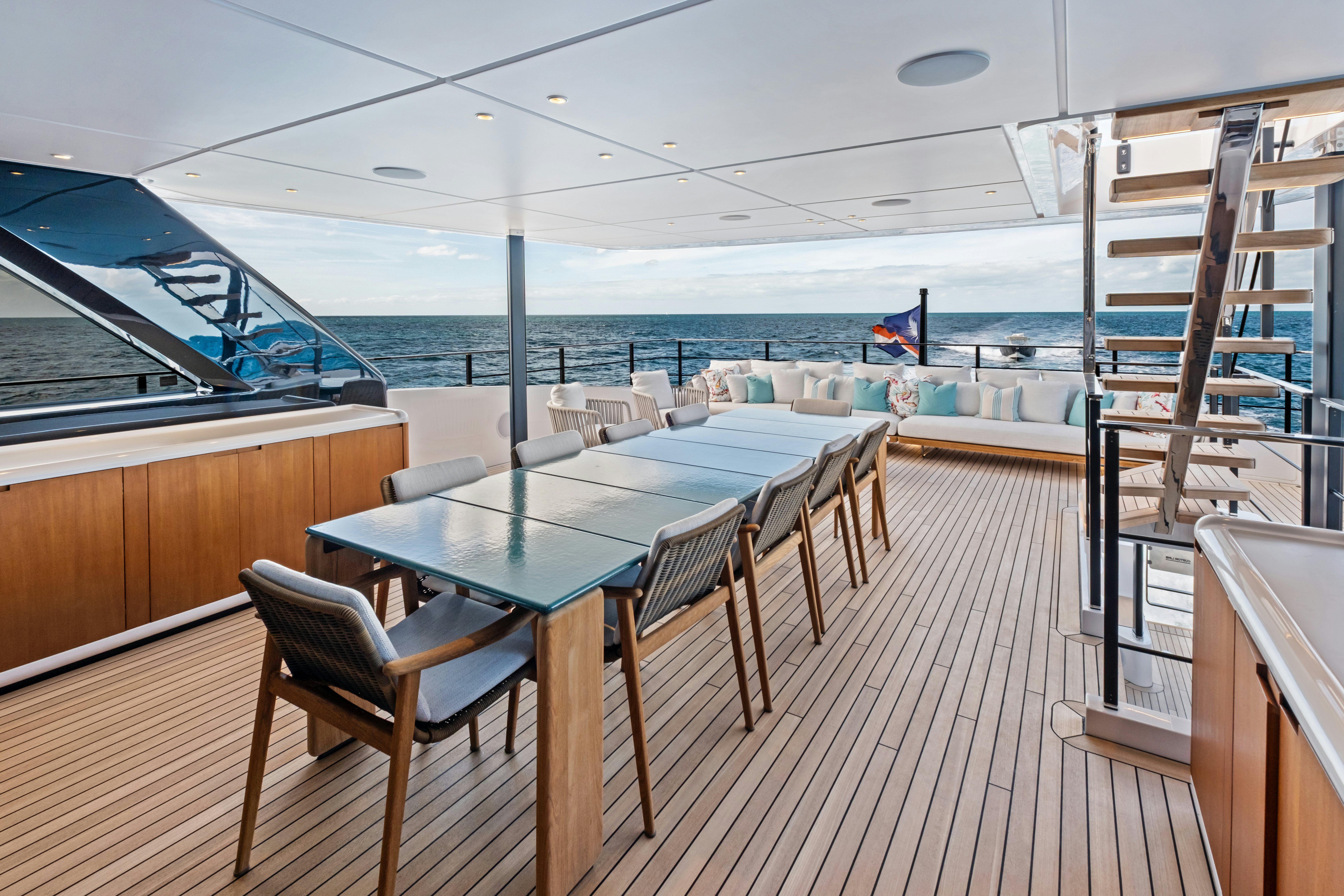 a room with a table chairs and a view of the water aboard CANOE CANOE Yacht for Charter