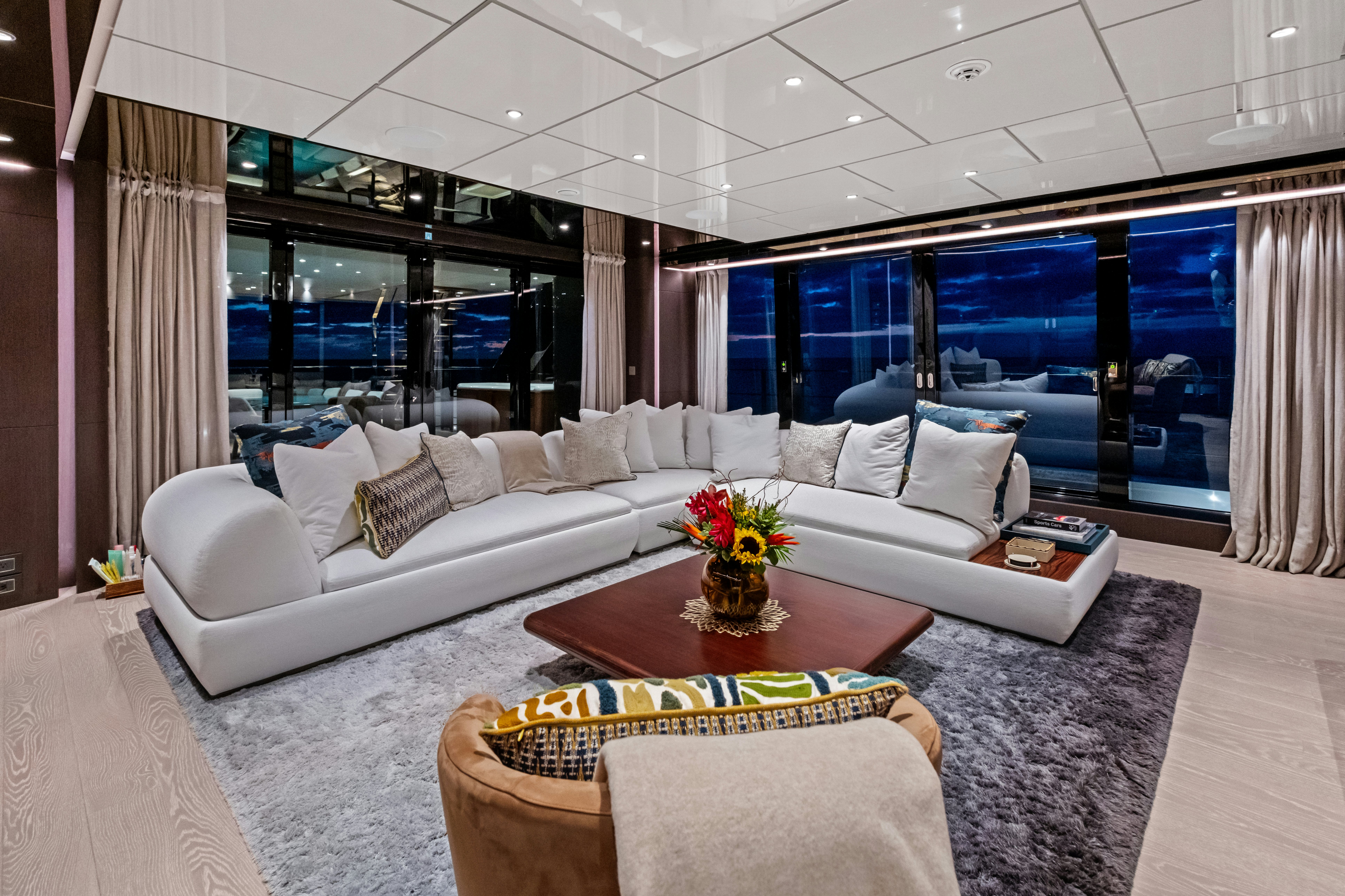 a living room with a large window aboard CANOE CANOE Yacht for Charter
