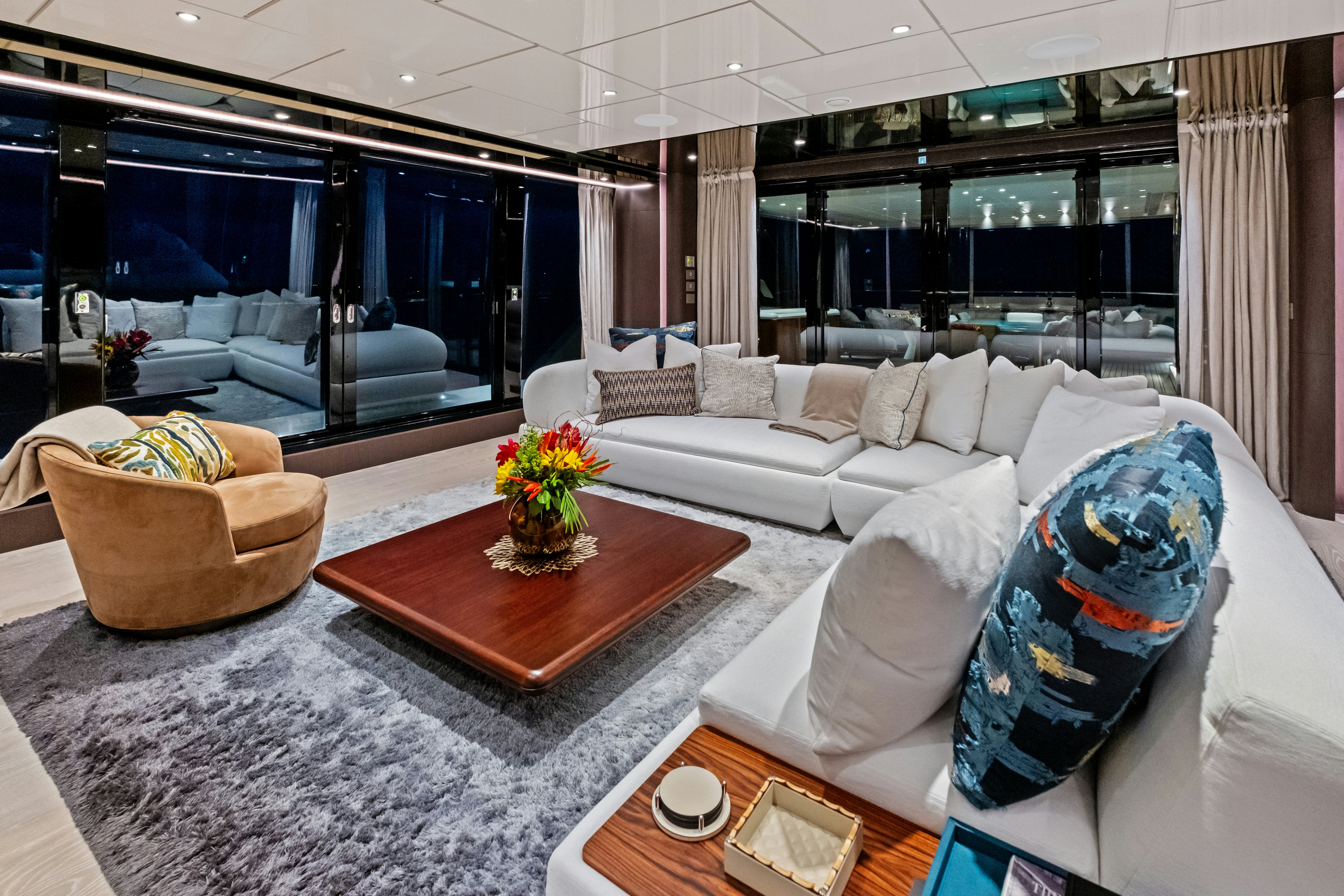 a living room with a large window aboard CANOE CANOE Yacht for Charter