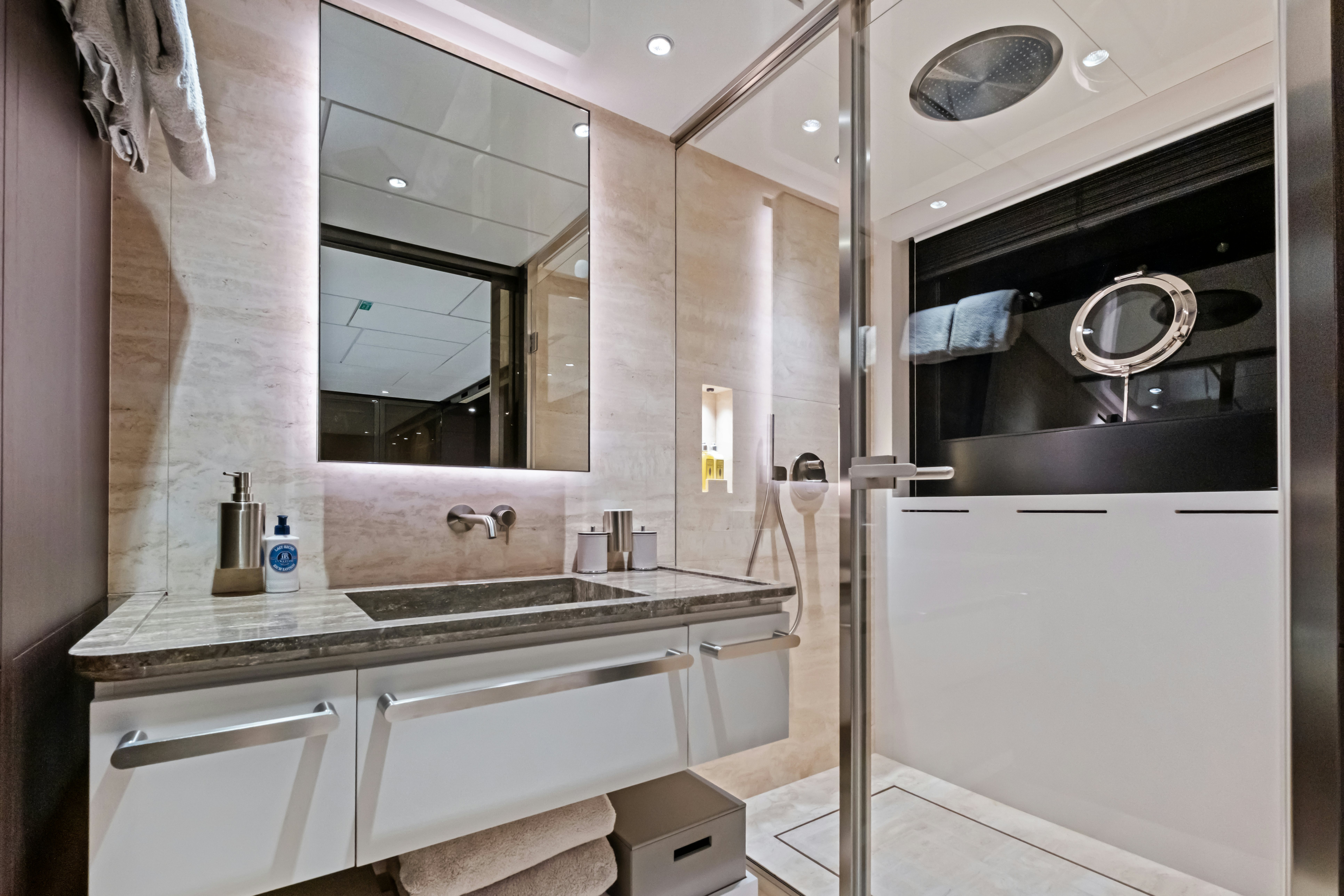 a bathroom with a large mirror aboard CANOE CANOE Yacht for Charter