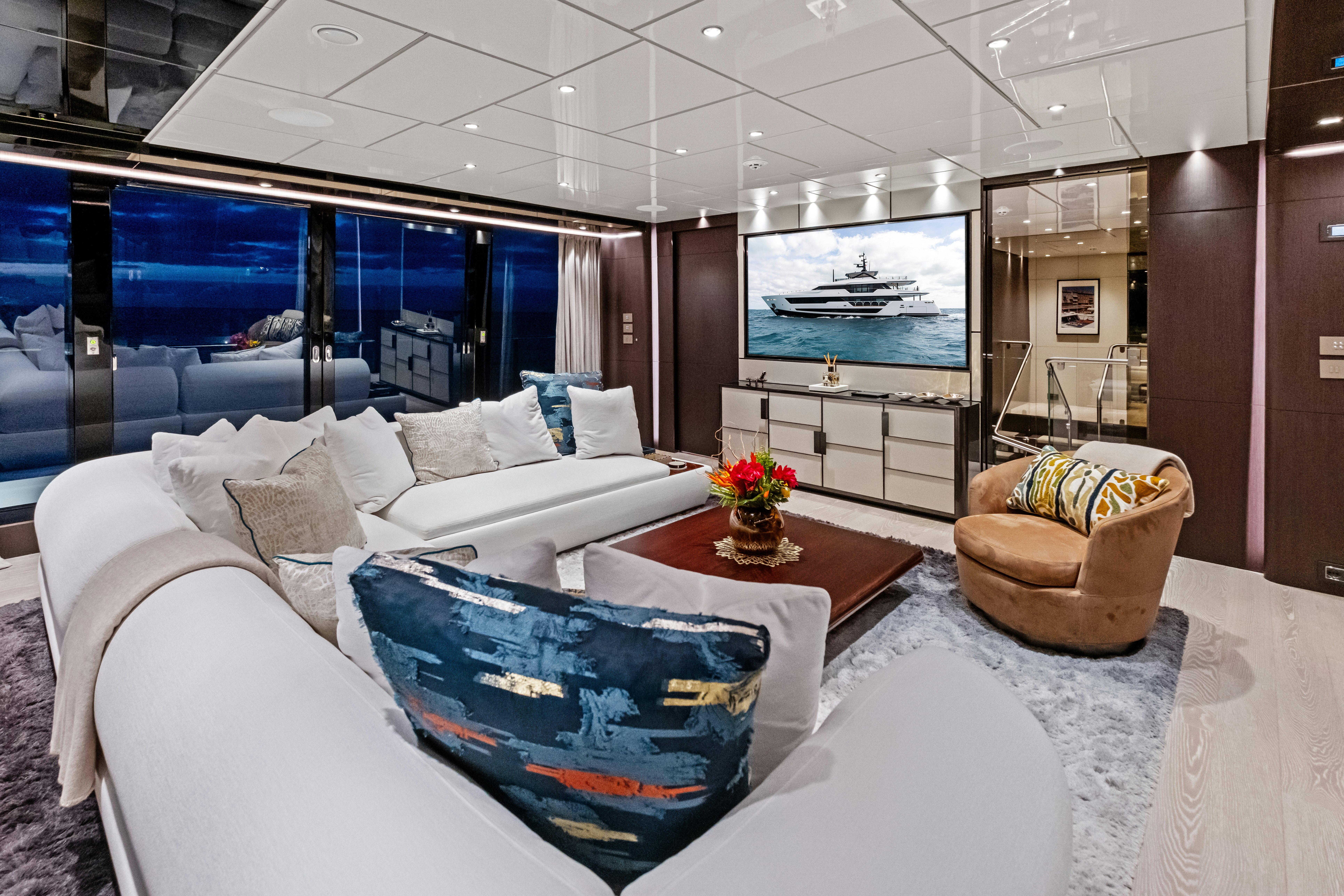 a living room with a large window aboard CANOE CANOE Yacht for Charter