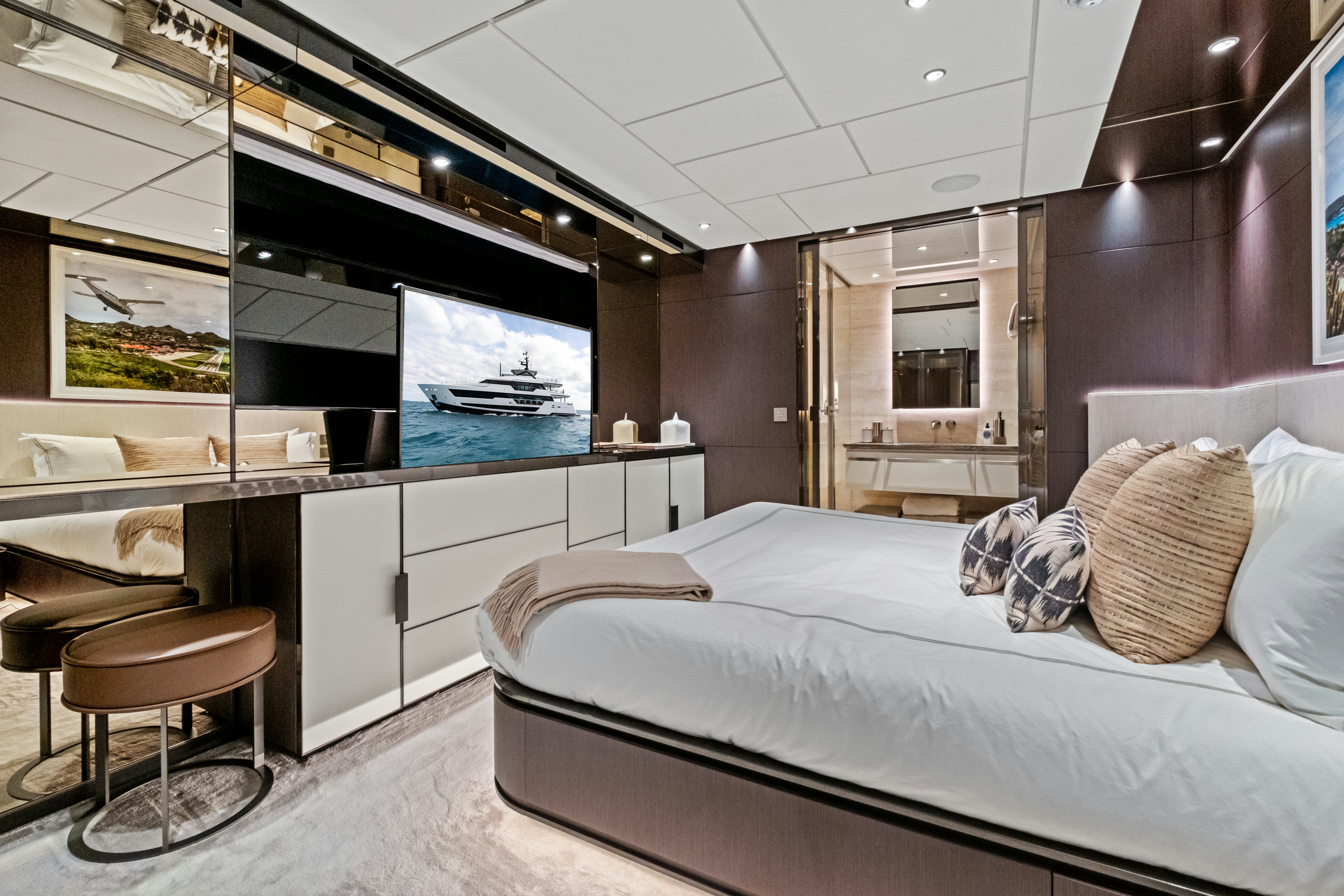 a bedroom with a bed and a tv aboard CANOE CANOE Yacht for Charter