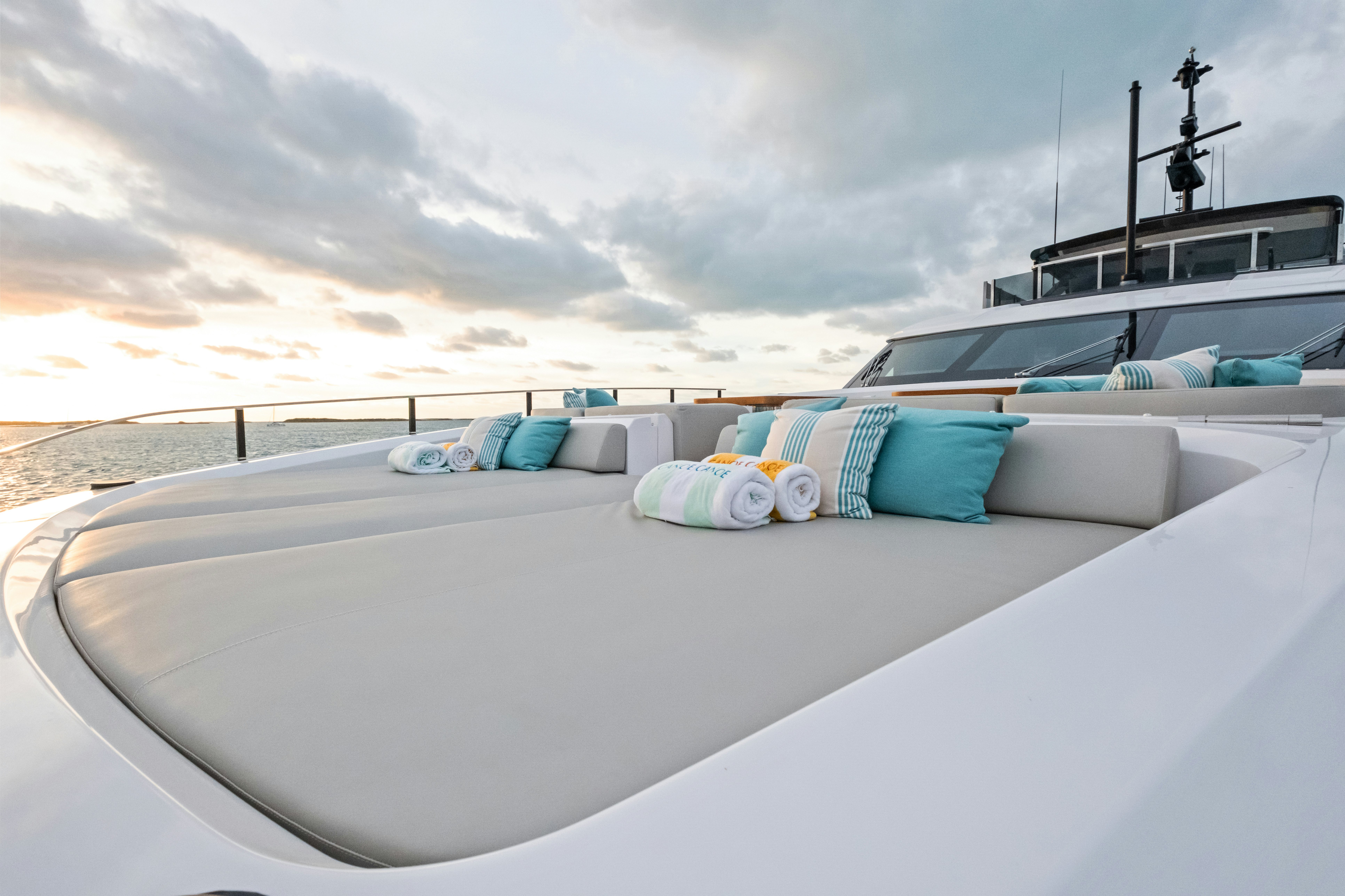 a white boat on a beach aboard CANOE CANOE Yacht for Charter