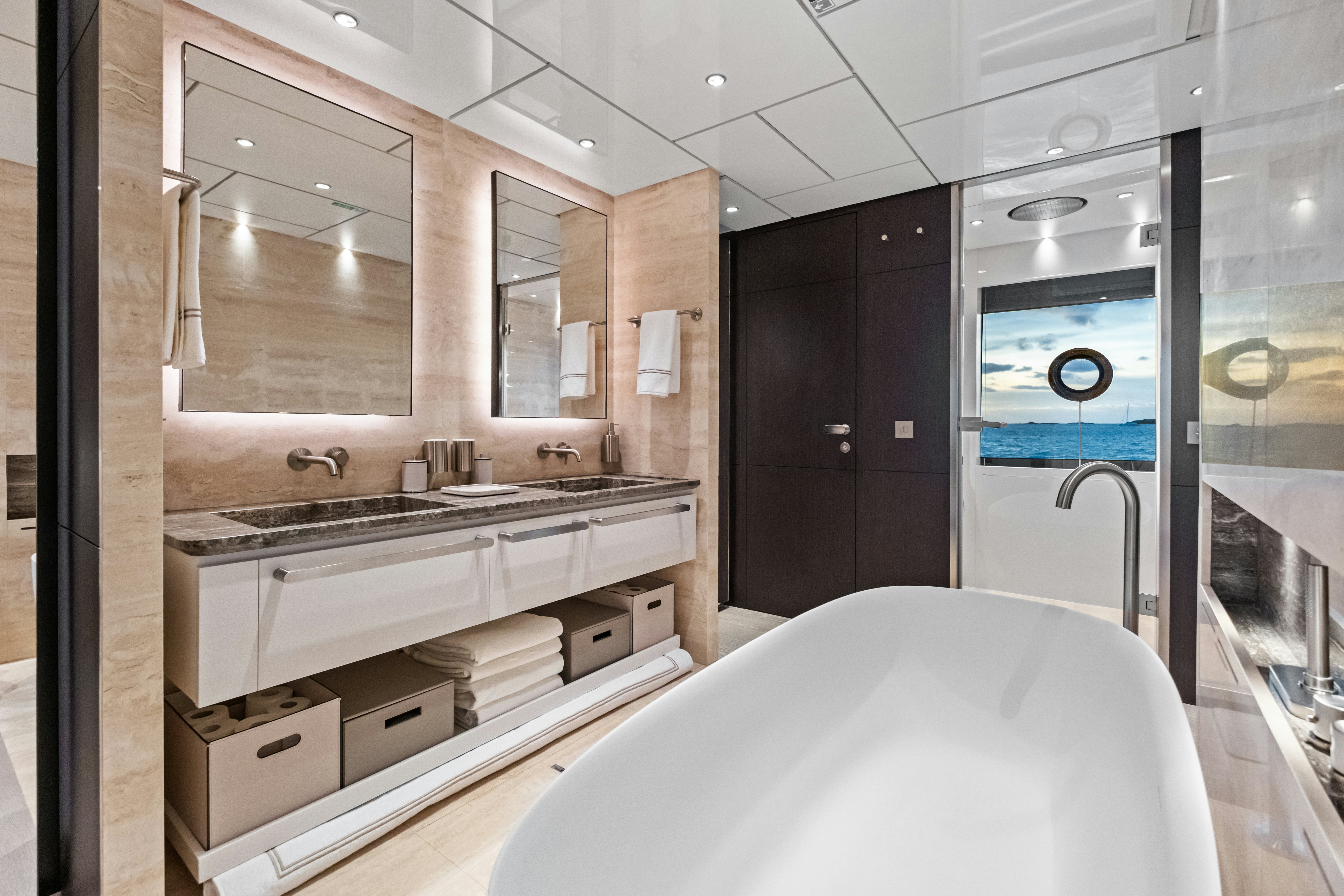 a bathroom with a bathtub sink and a mirror aboard CANOE CANOE Yacht for Charter