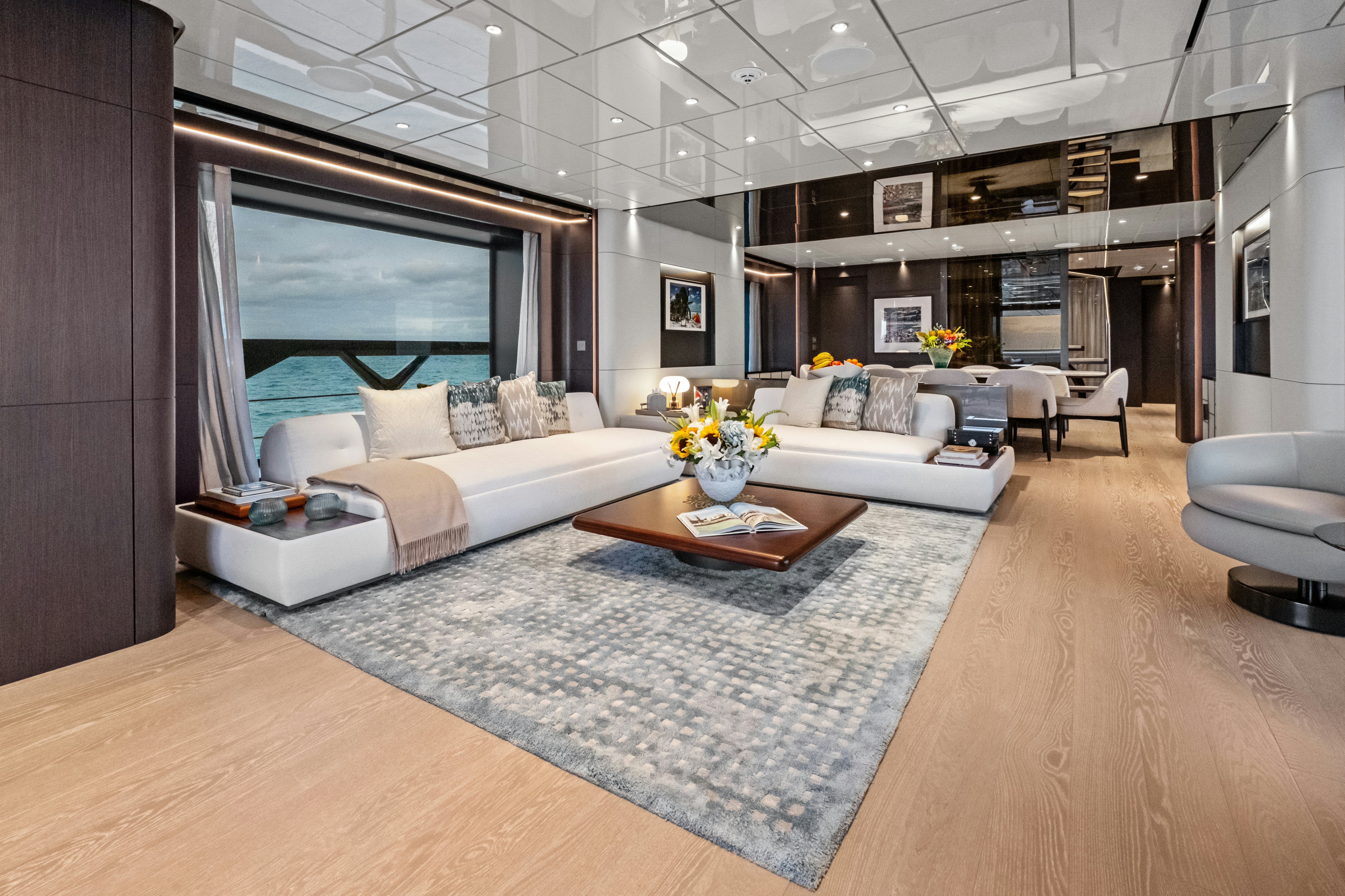 a large living room with a large rug aboard CANOE CANOE Yacht for Charter