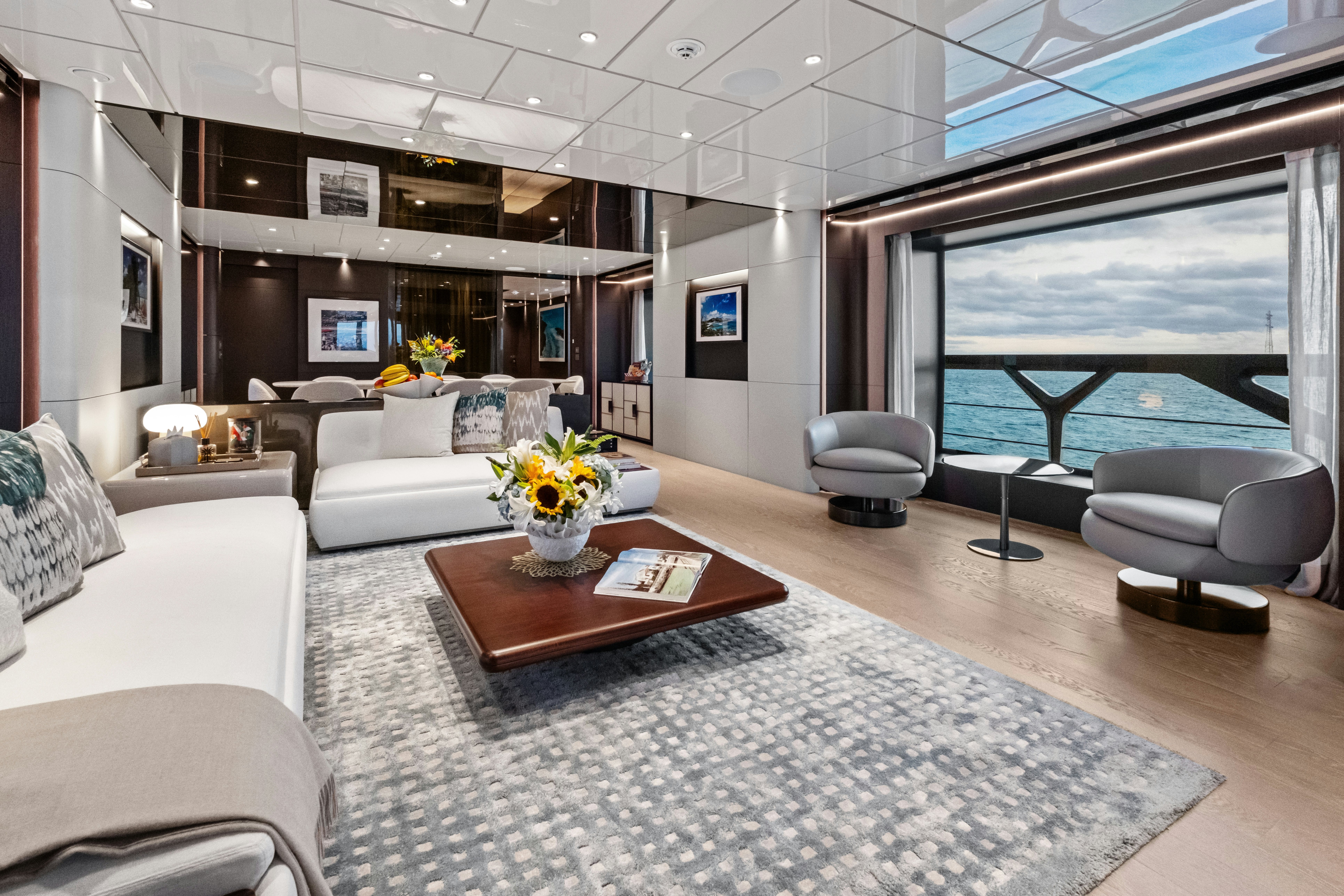 a living room with a large window aboard CANOE CANOE Yacht for Charter
