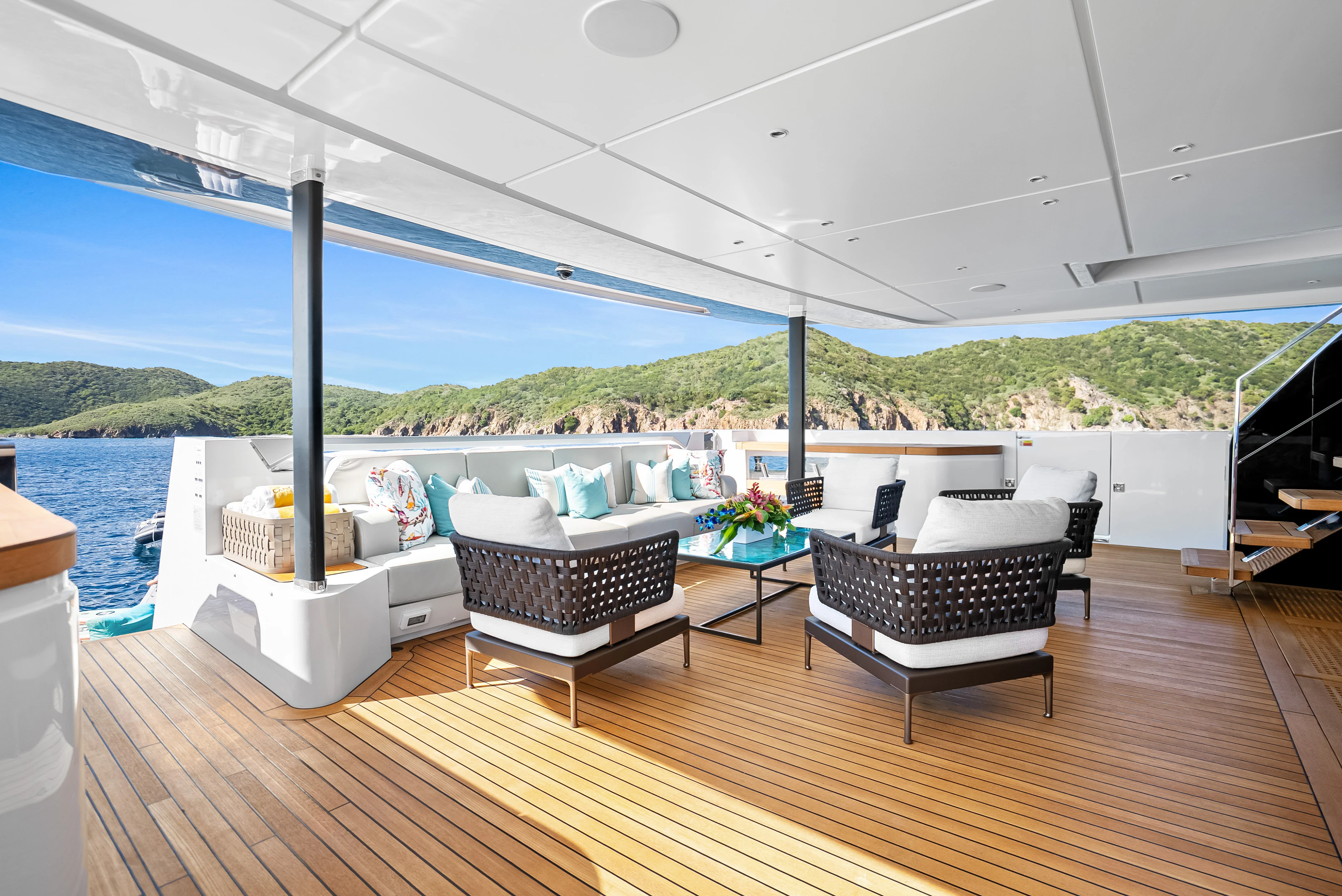 a deck with a table and chairs on it aboard CANOE CANOE Yacht for Charter