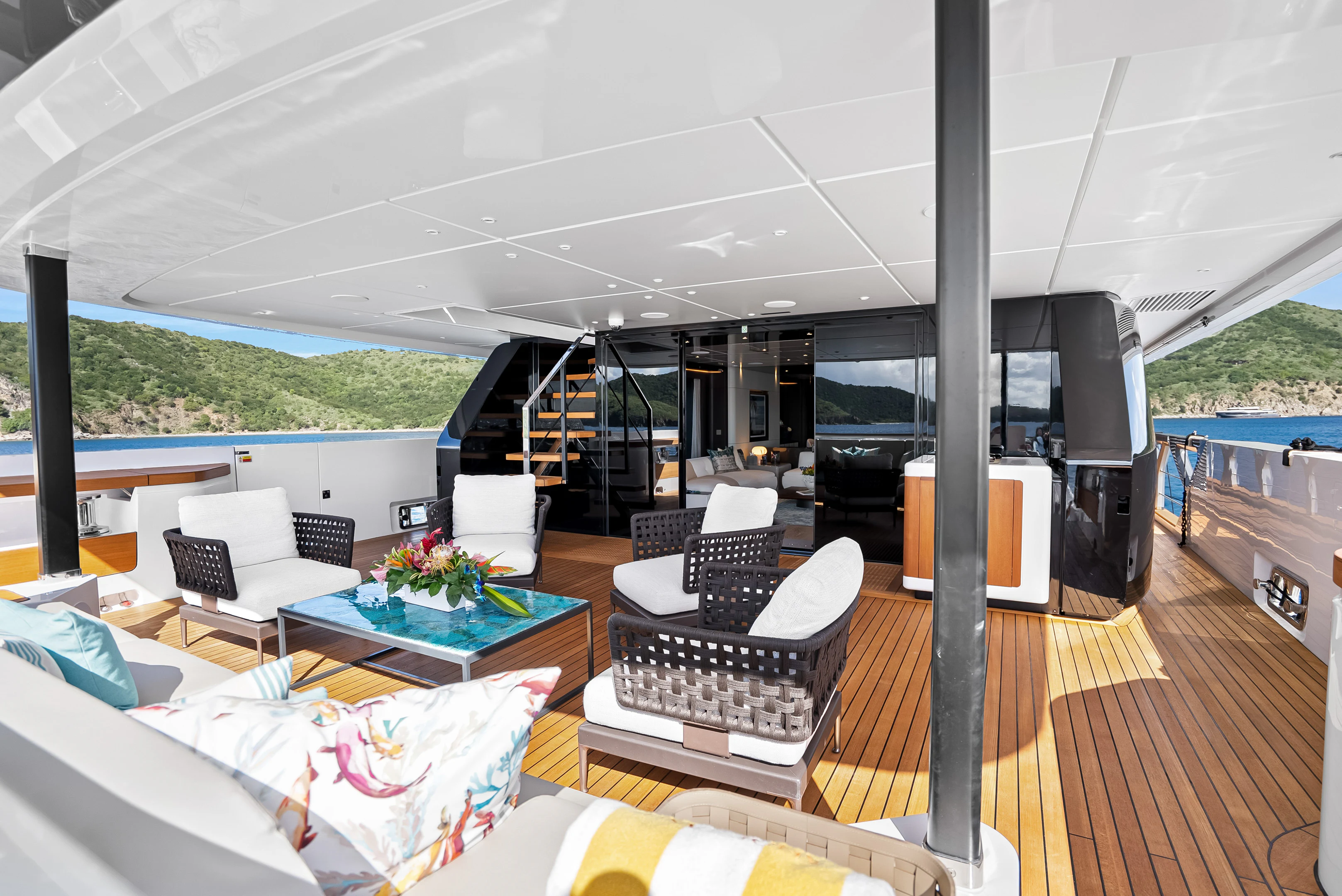 a living room with a large deck aboard CANOE CANOE Yacht for Charter