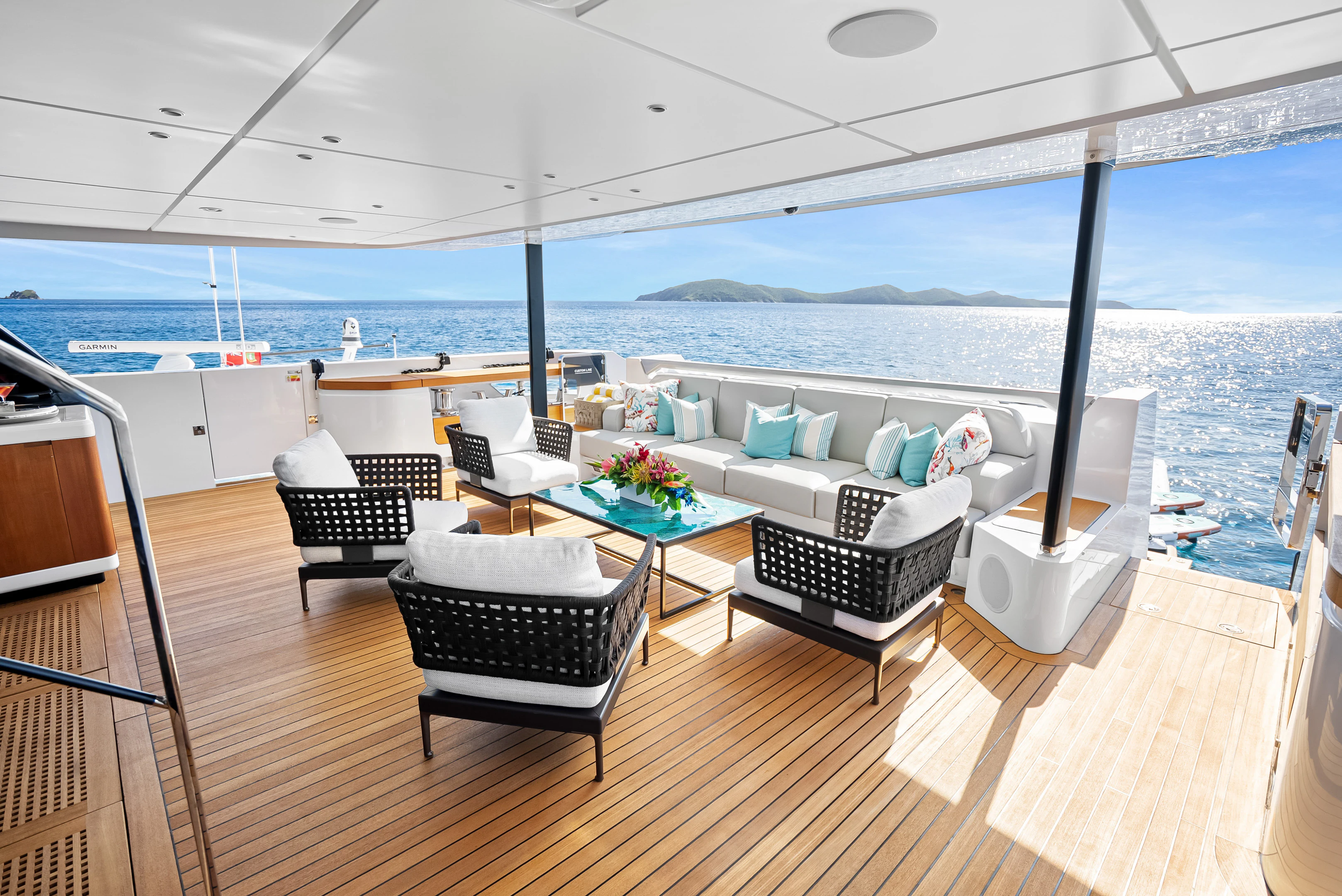 a room with a couch and a table and chairs on a deck aboard CANOE CANOE Yacht for Charter
