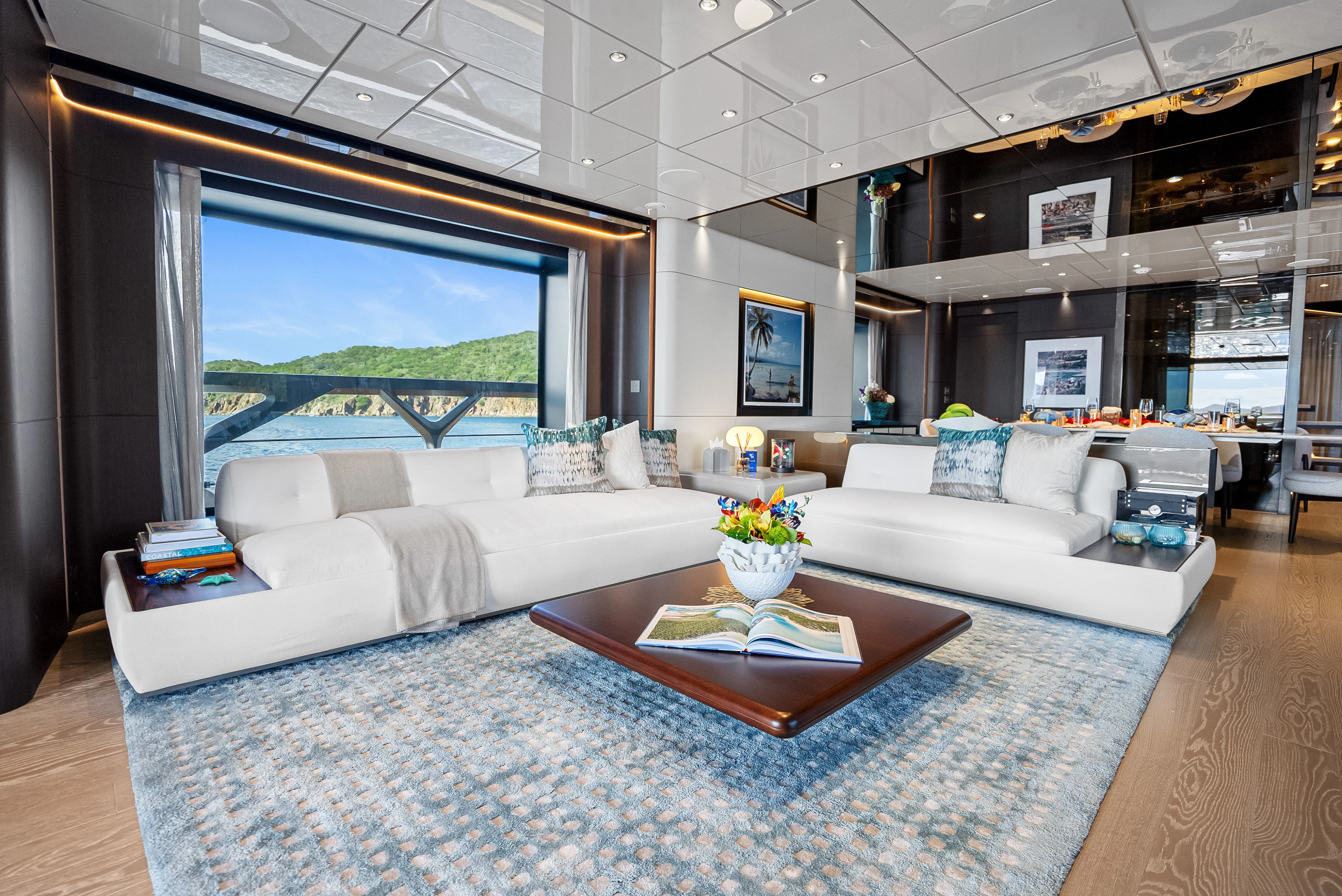 a living room with a large window aboard CANOE CANOE Yacht for Charter