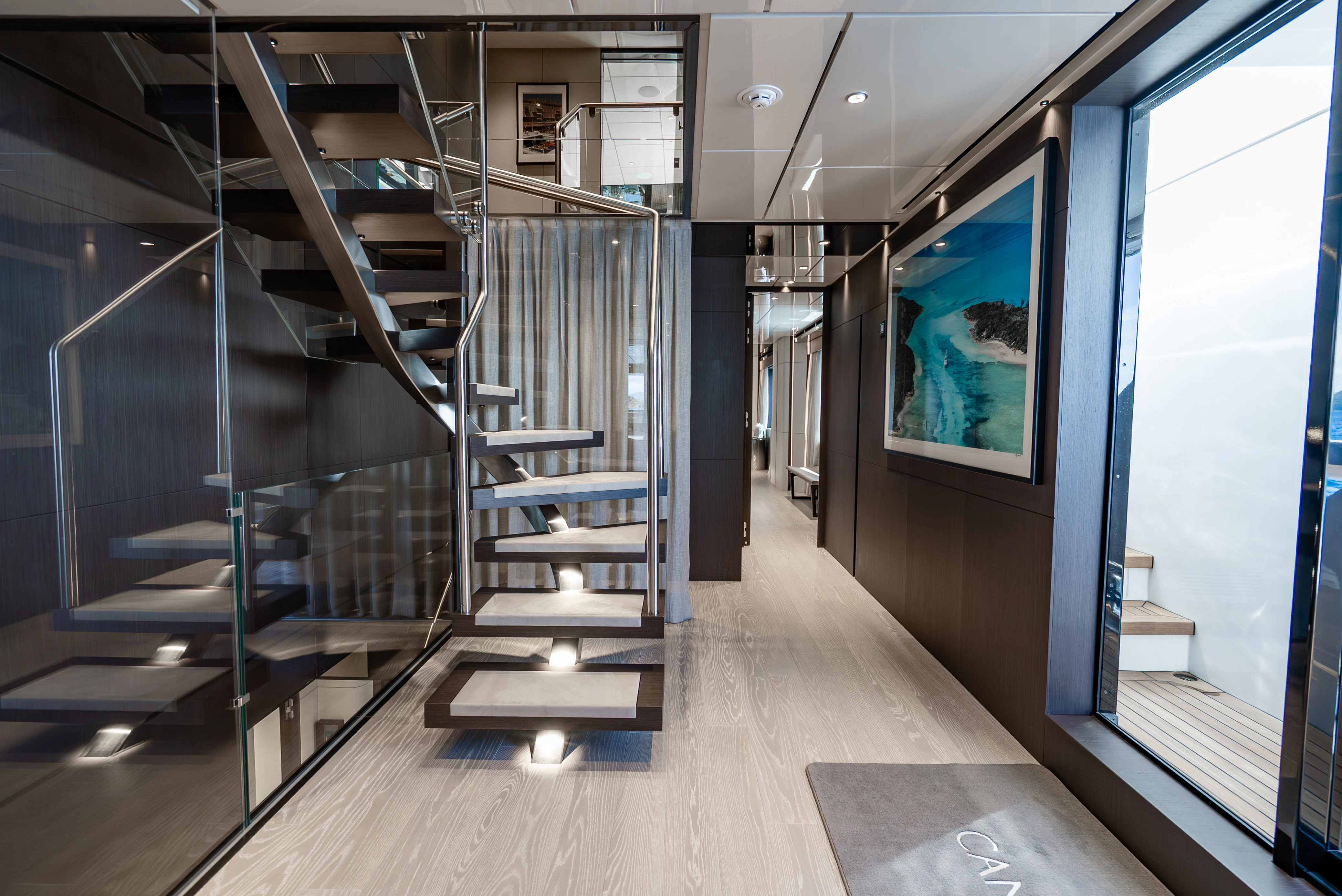 a room with a staircase and glass walls aboard CANOE CANOE Yacht for Charter