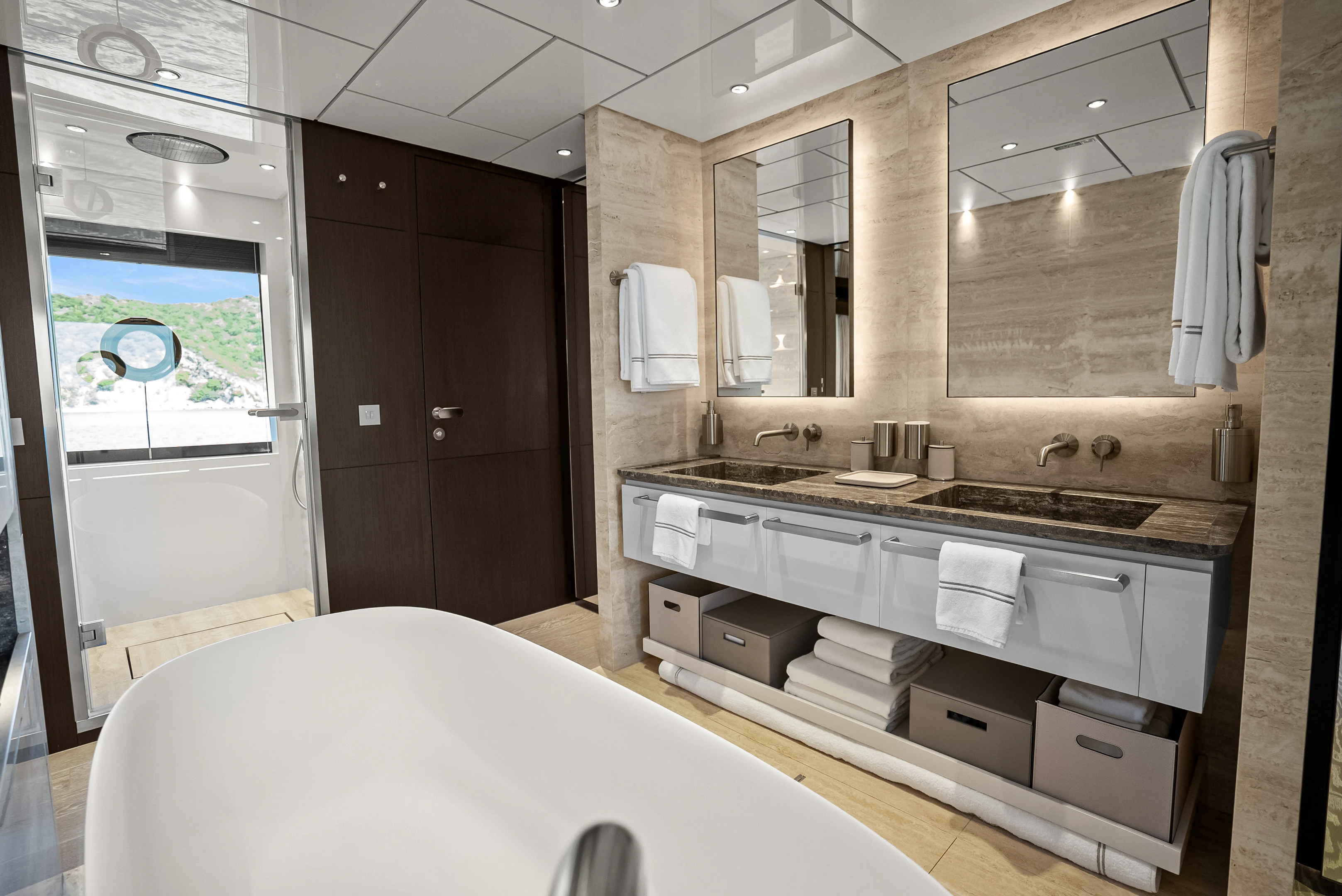 a bathroom with a tub sink and a mirror aboard CANOE CANOE Yacht for Charter