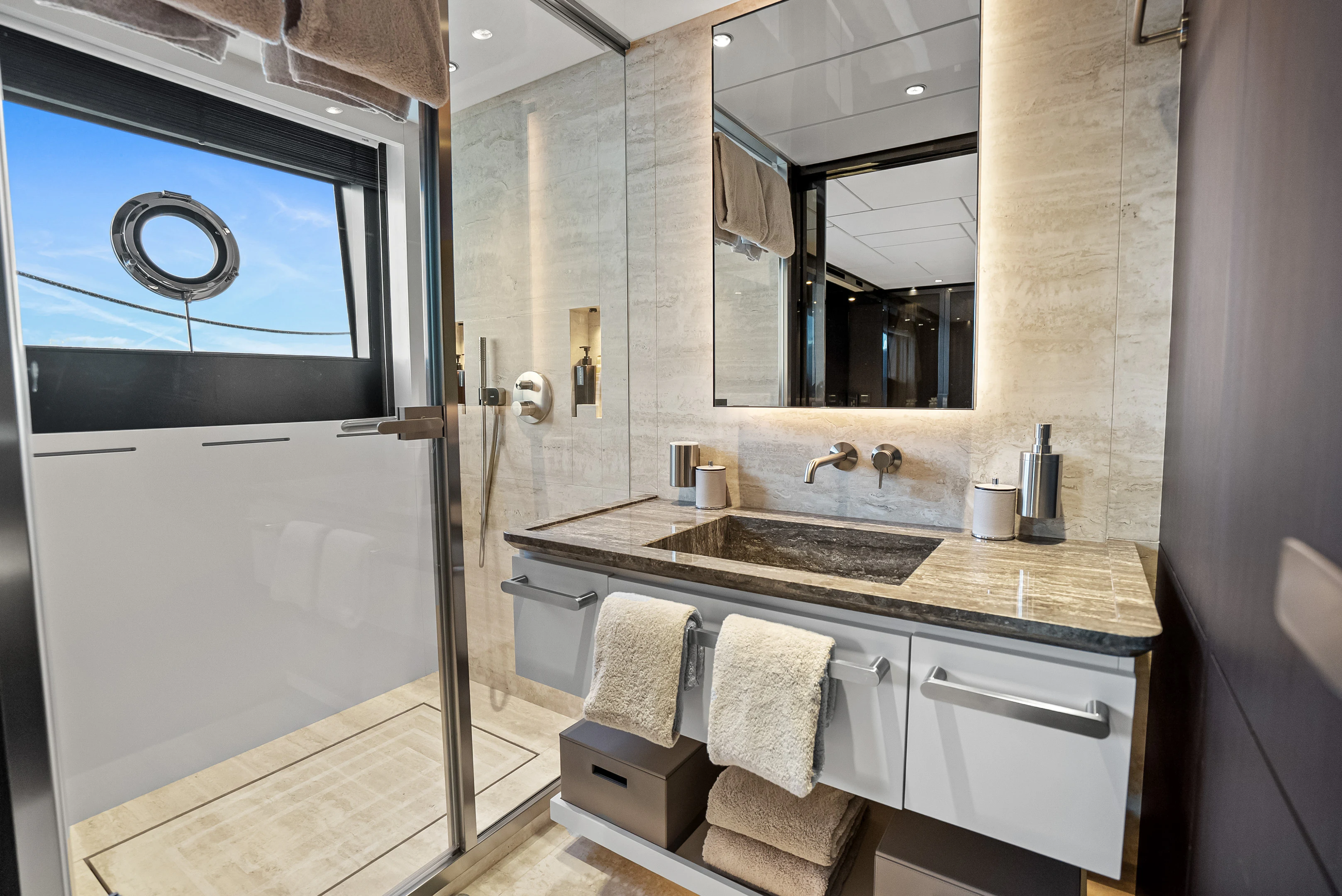 a bathroom with a sink and a mirror aboard CANOE CANOE Yacht for Charter