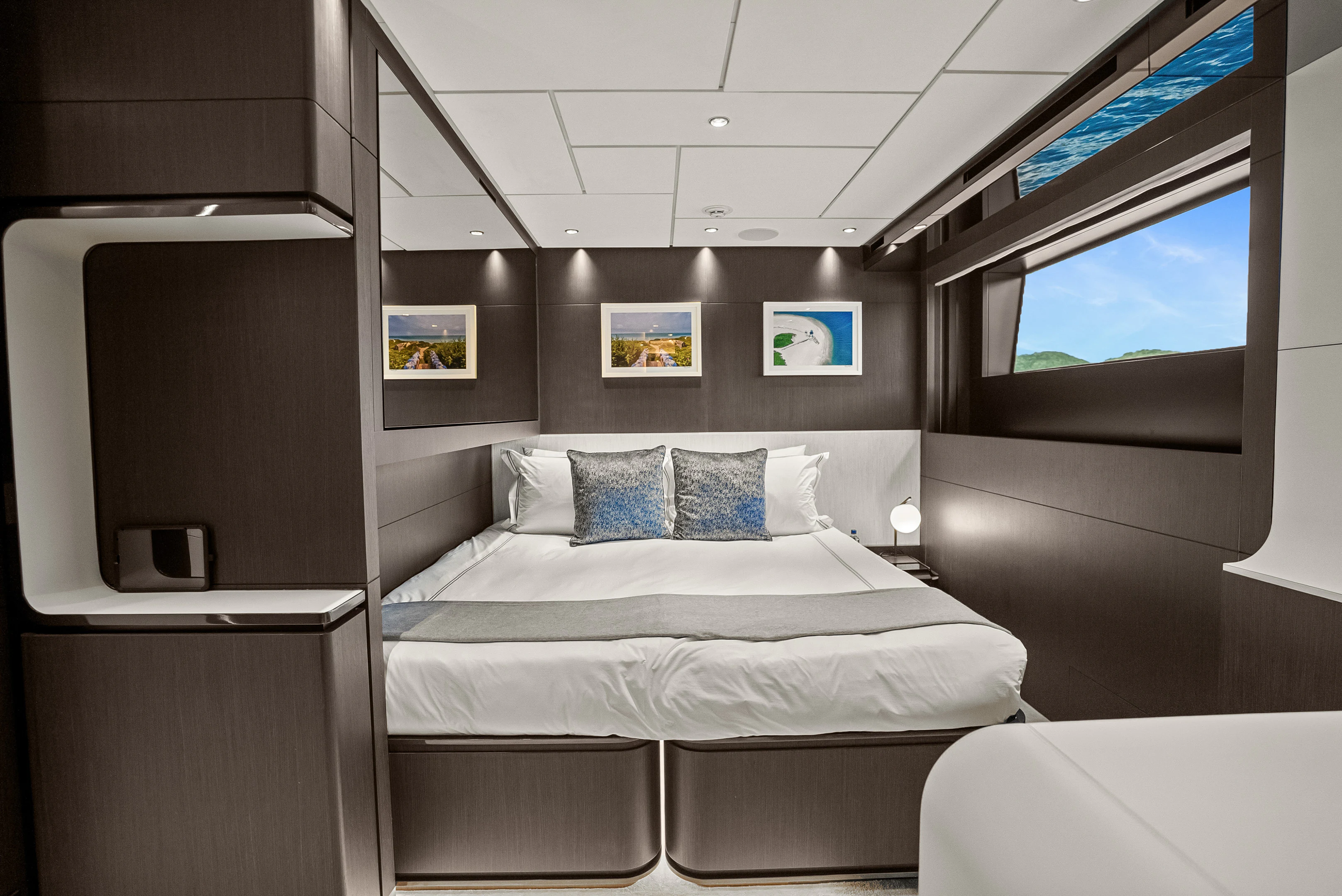 a room with a bed and a television aboard CANOE CANOE Yacht for Charter