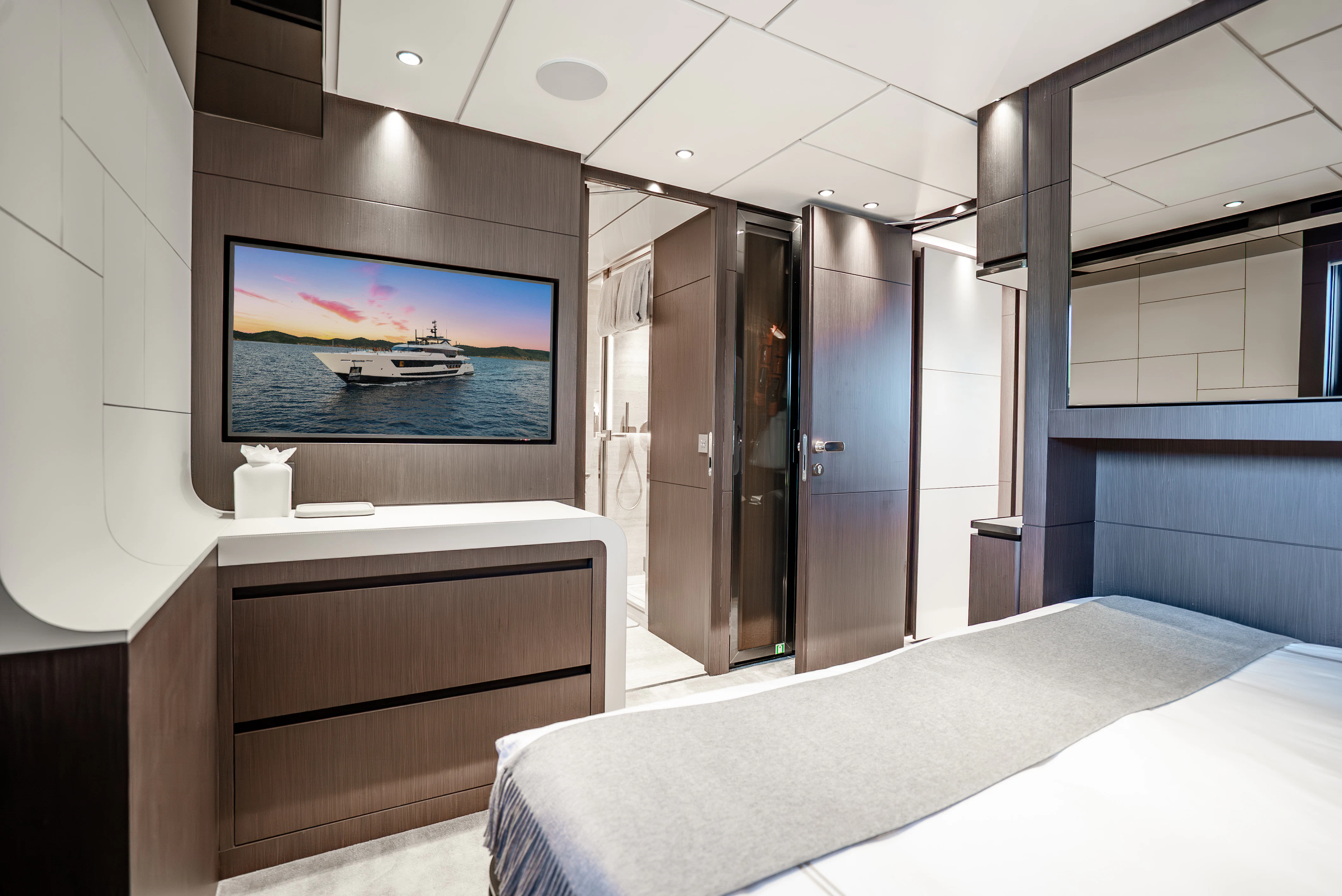a room with a bed and a tv on the wall aboard CANOE CANOE Yacht for Charter