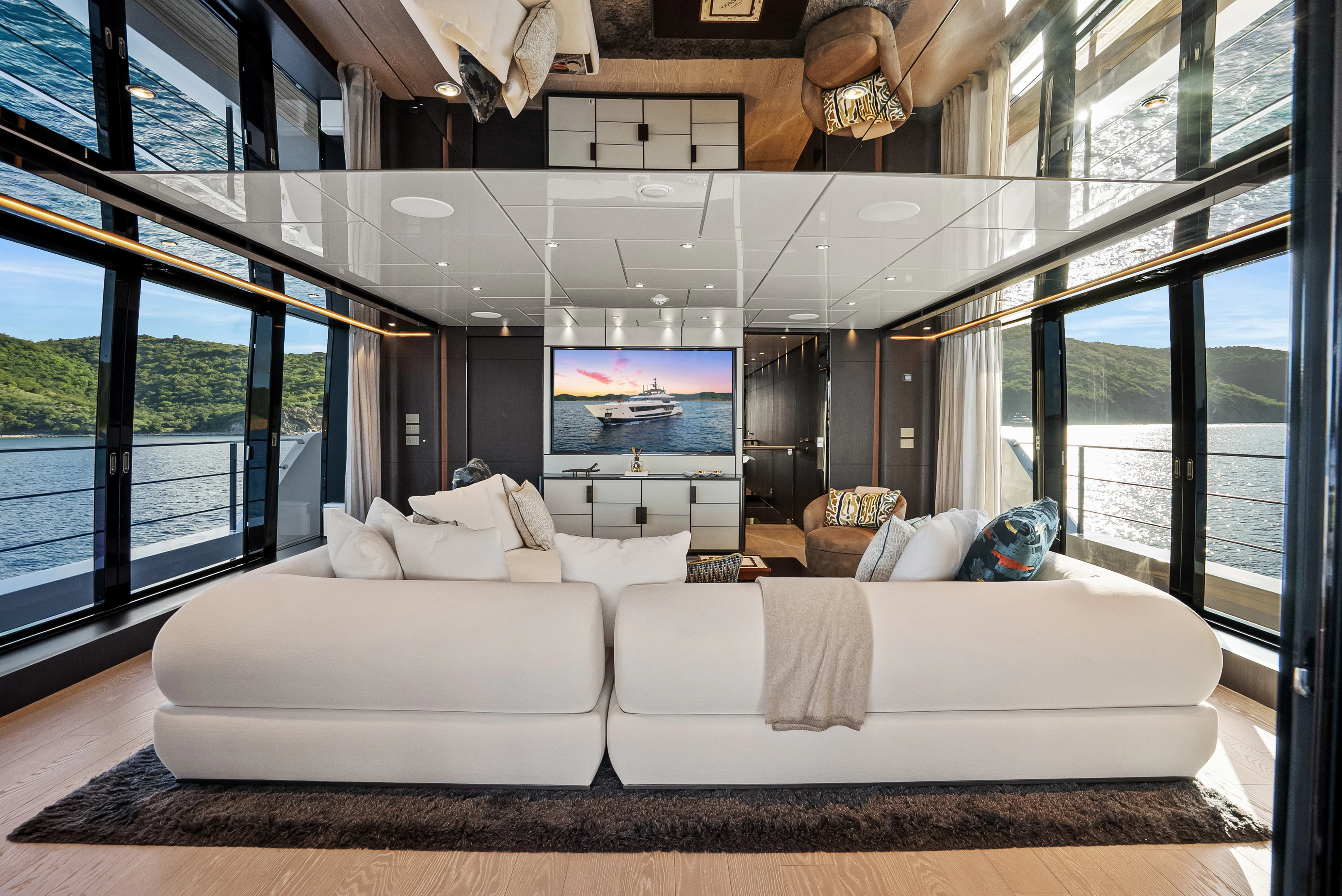 a large living room with a large screen aboard CANOE CANOE Yacht for Charter
