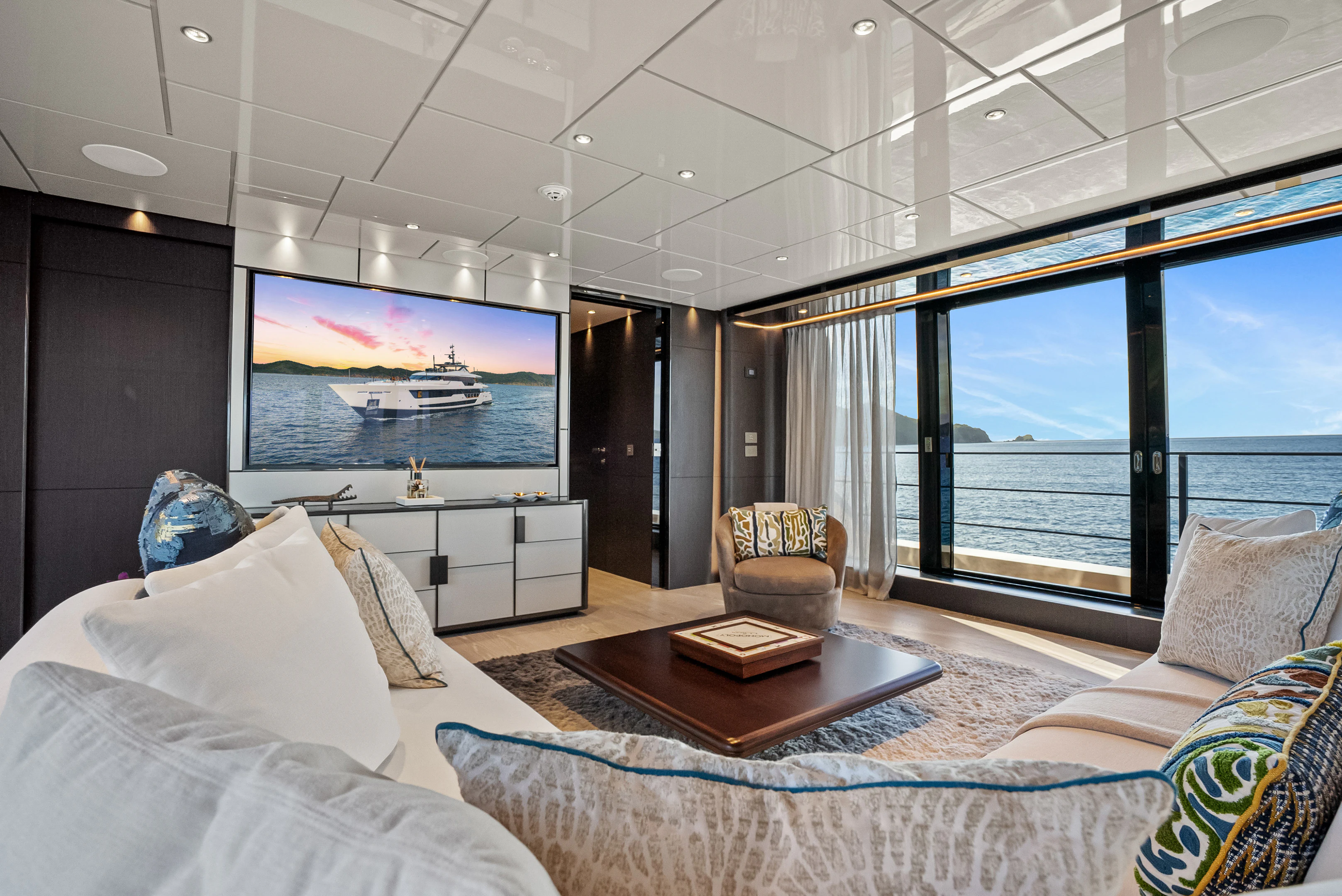 a living room with a large screen aboard CANOE CANOE Yacht for Charter
