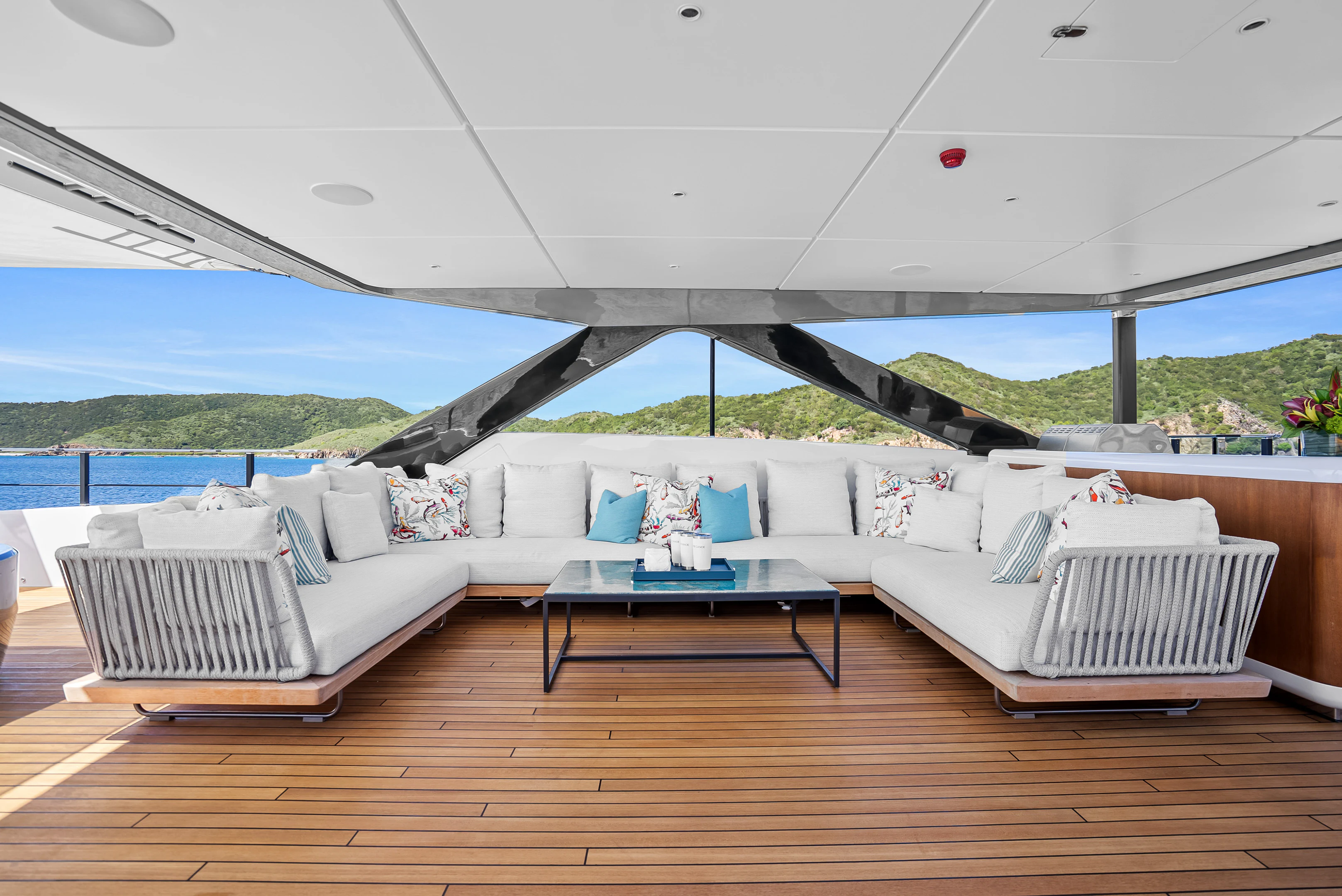 a living room with a large white couch and a large tent aboard CANOE CANOE Yacht for Charter