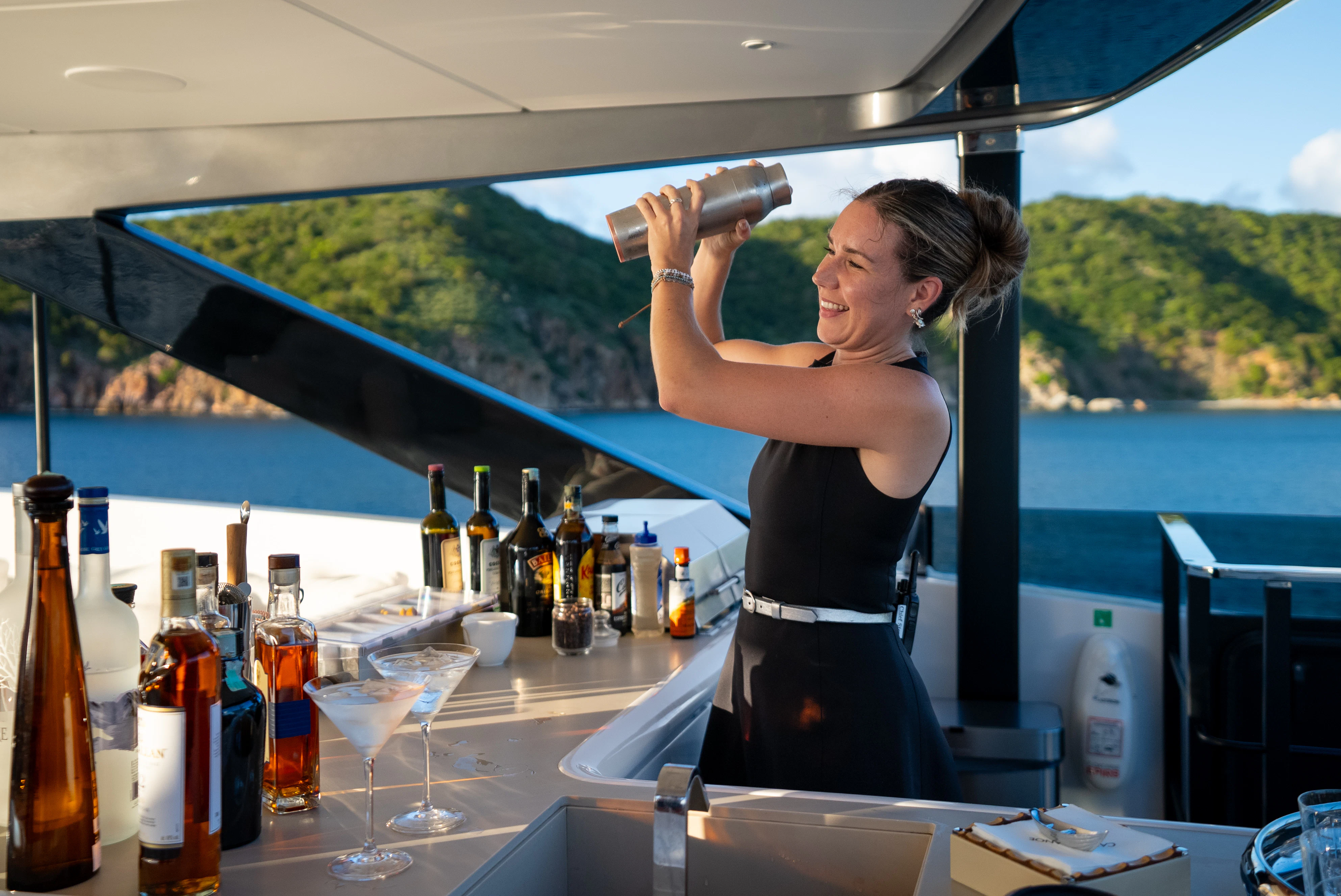 a woman drinking from a glass aboard CANOE CANOE Yacht for Charter