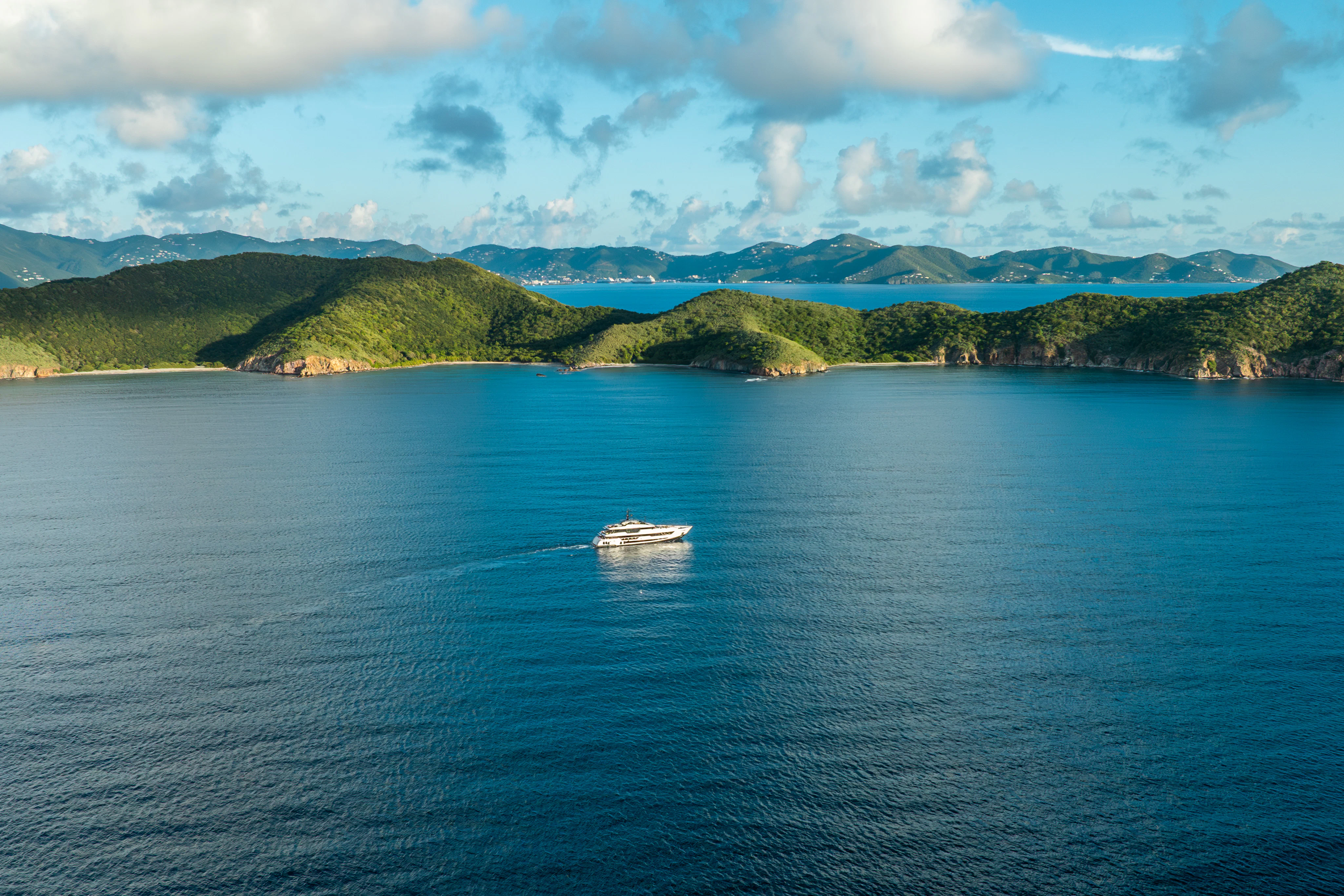 a body of water with hills in the background aboard CANOE CANOE Yacht for Charter