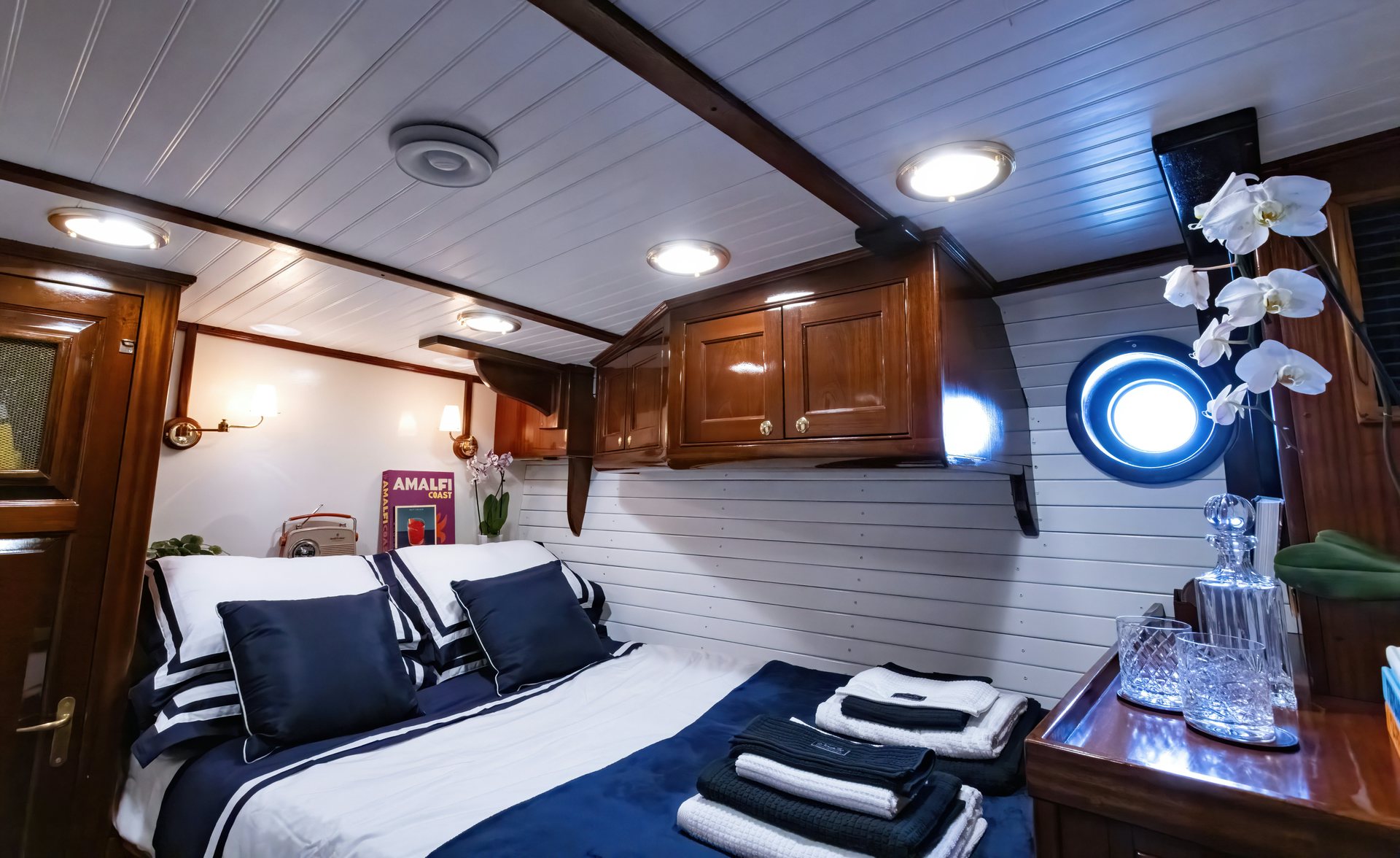 a room with a bed and a table aboard HERMITAGE Yacht for Sale