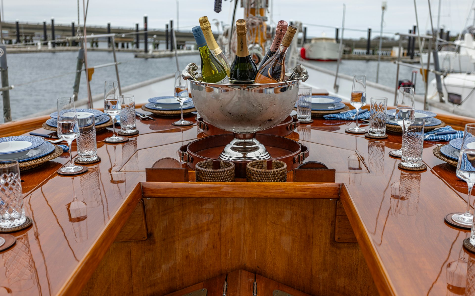 a table with wine bottles and glasses on it aboard HERMITAGE Yacht for Sale