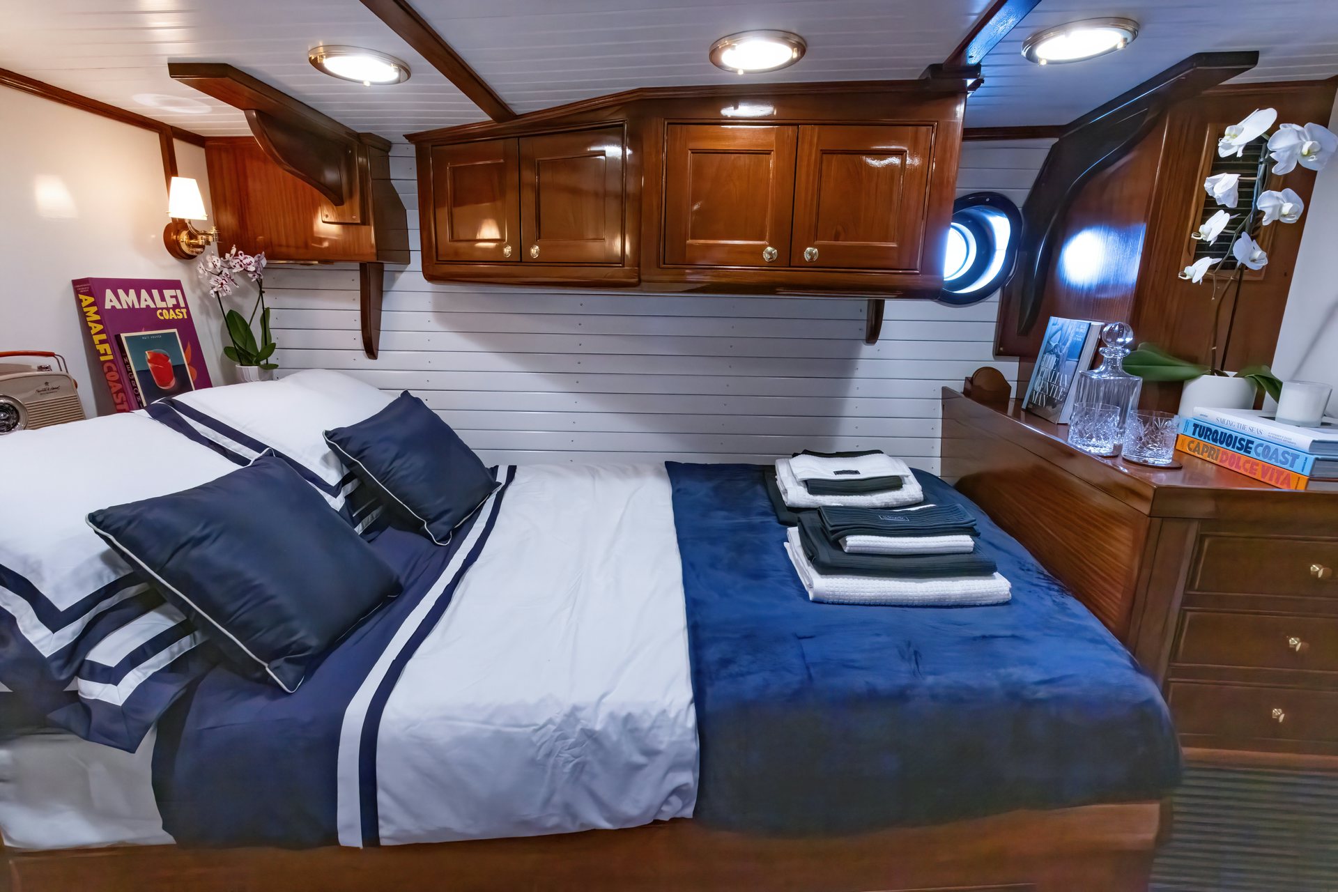 a bed with a blue sheet aboard HERMITAGE Yacht for Sale