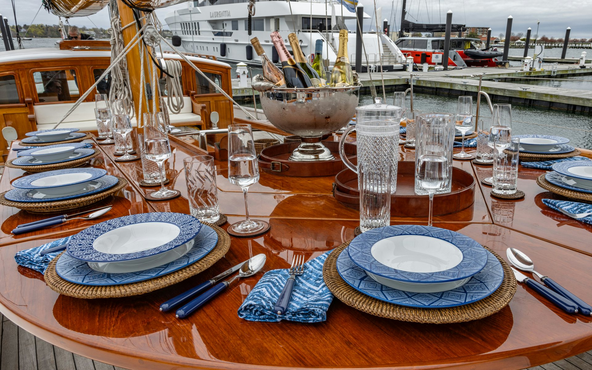a table with plates and glasses aboard HERMITAGE Yacht for Sale